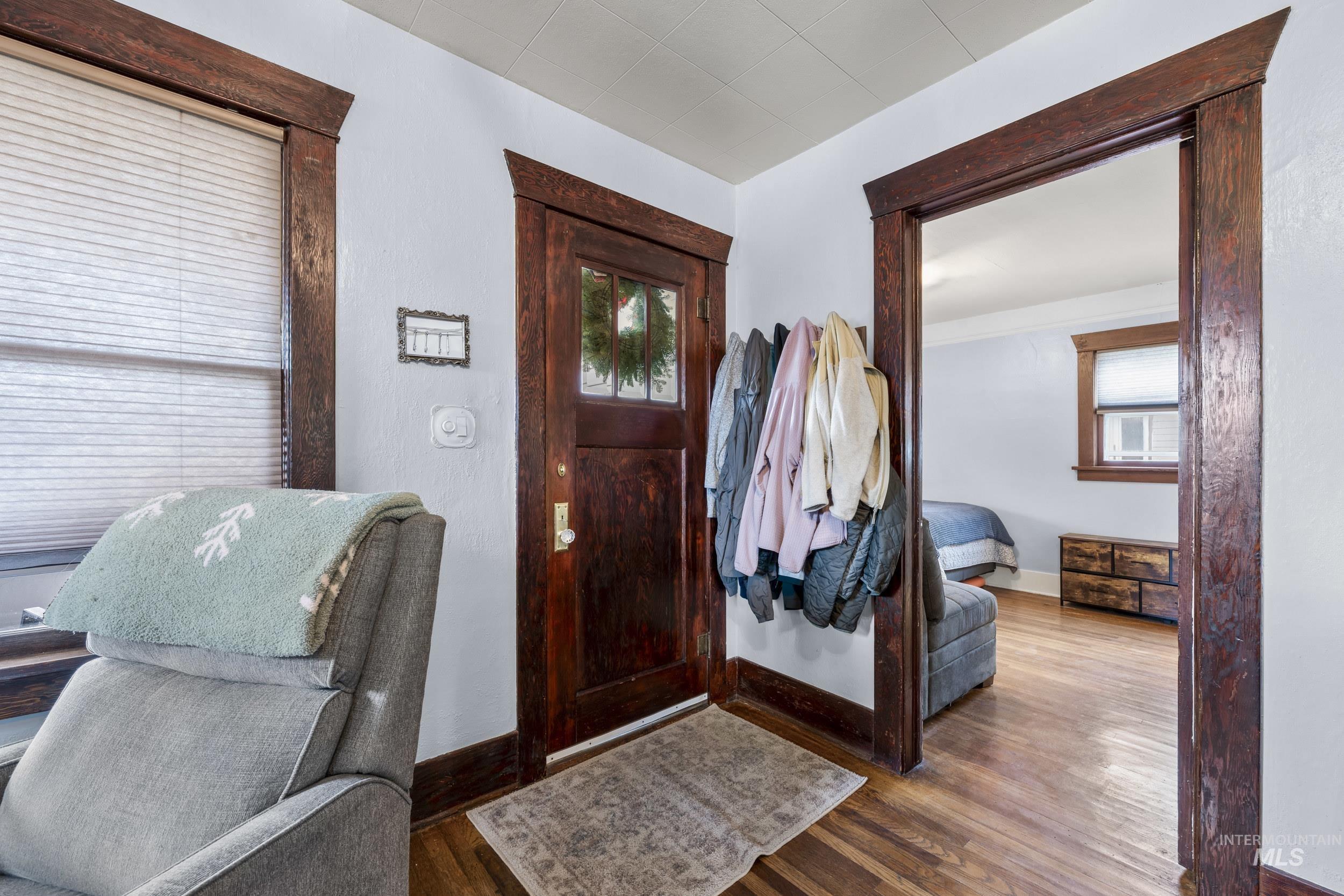 Foyer entrance with baseboards and wood finished floors