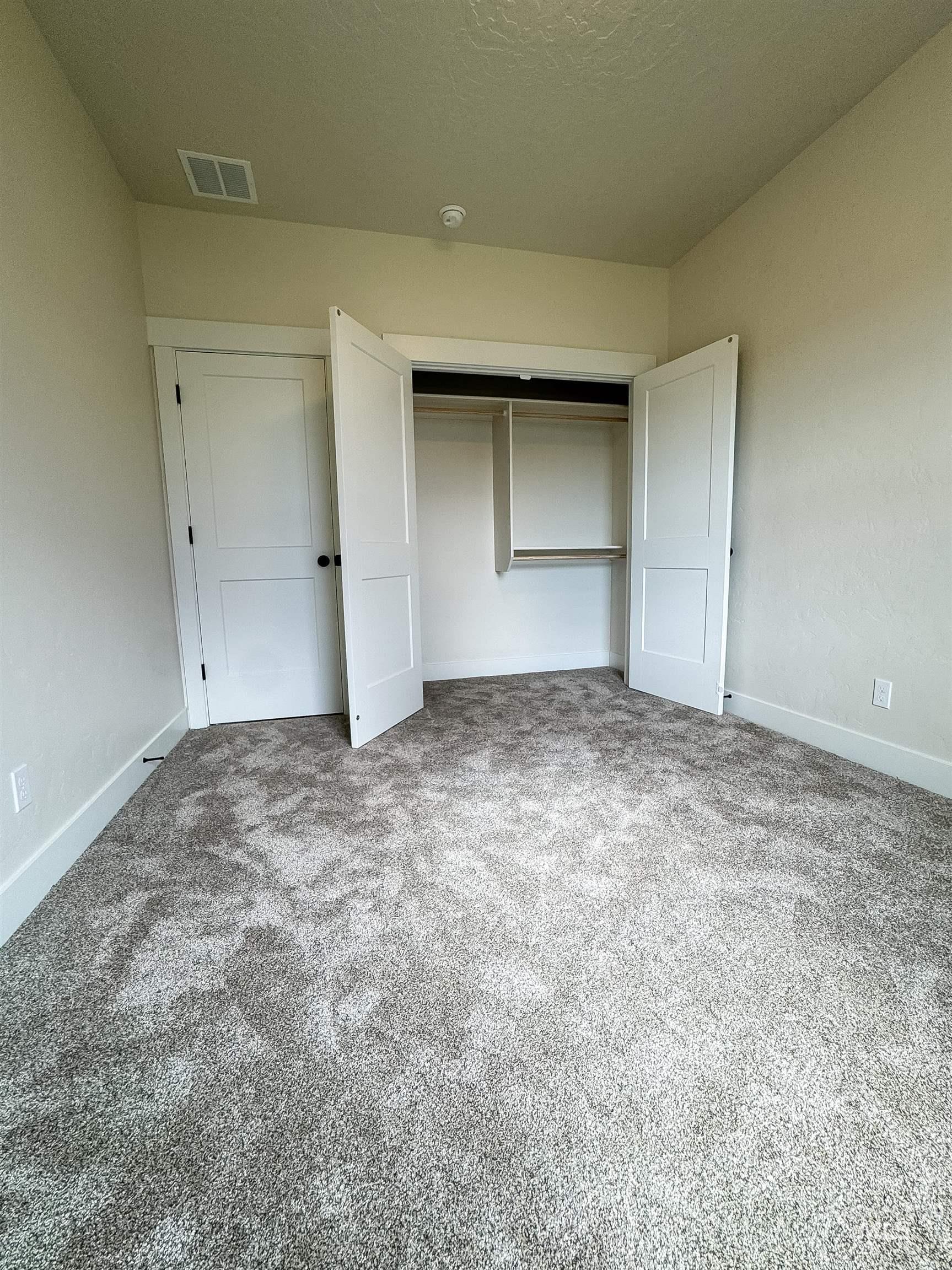 Unfurnished bedroom with carpet and a closet