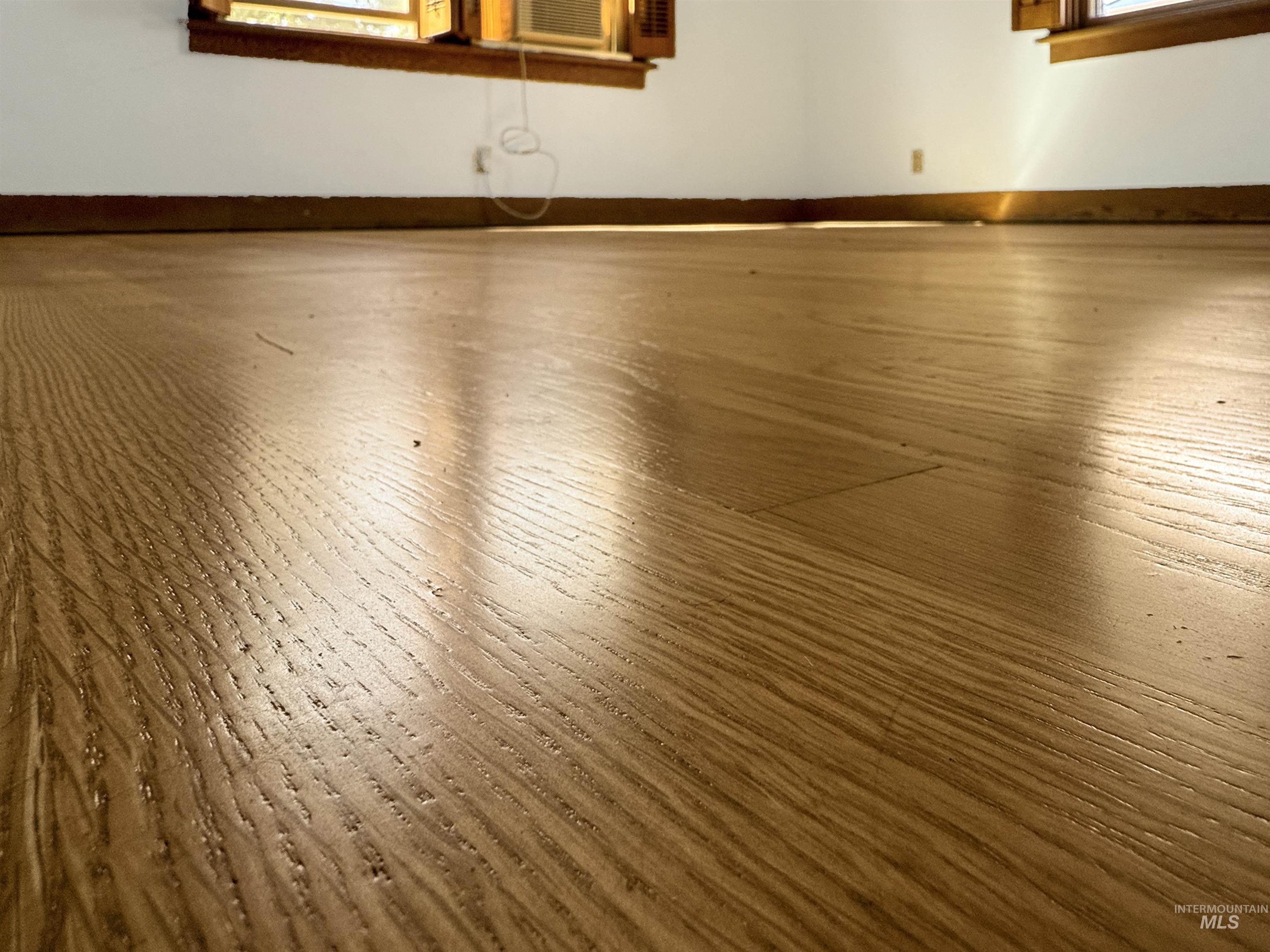 Detailed view of wood finished floors and baseboards