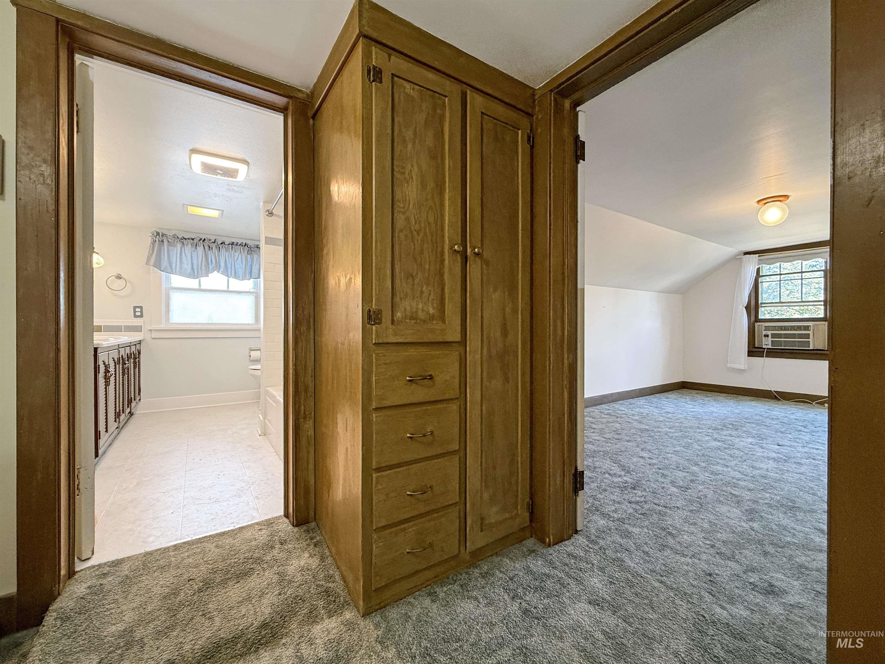 Bonus room featuring light carpet and lofted ceiling