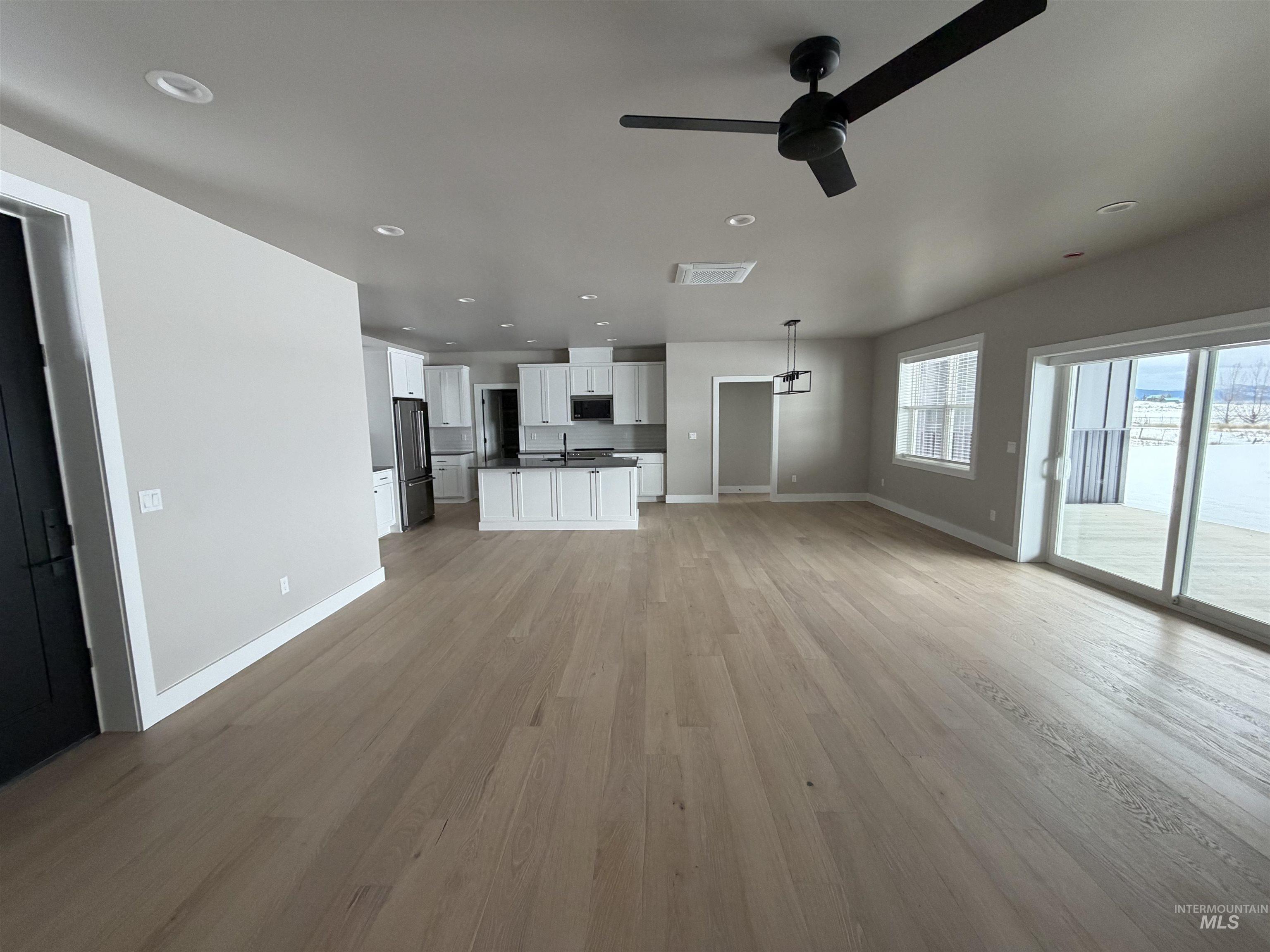 Unfurnished living room featuring recessed lighting, light wood-style flooring, and a ceiling fan