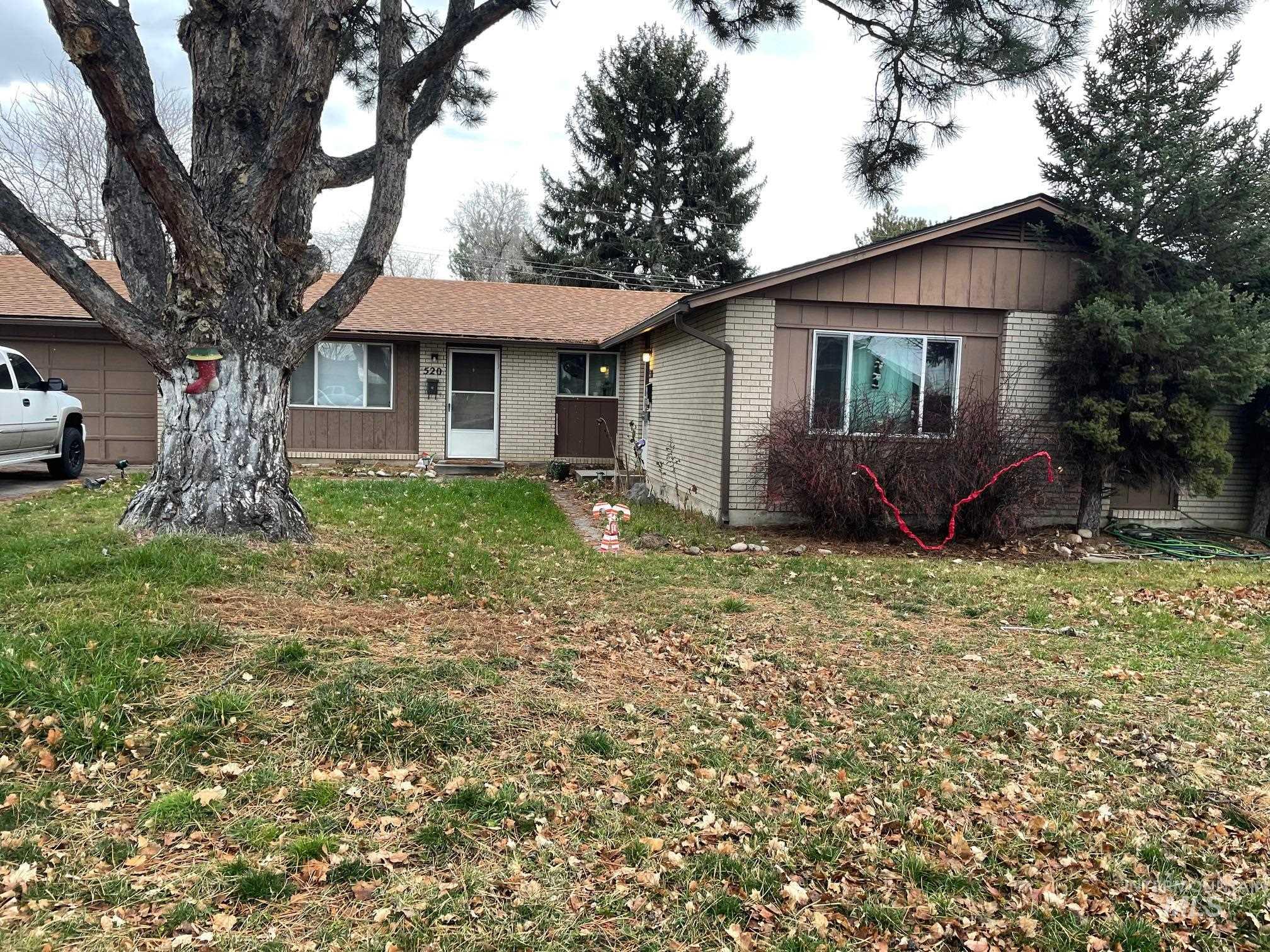Single story home with brick siding and a front lawn