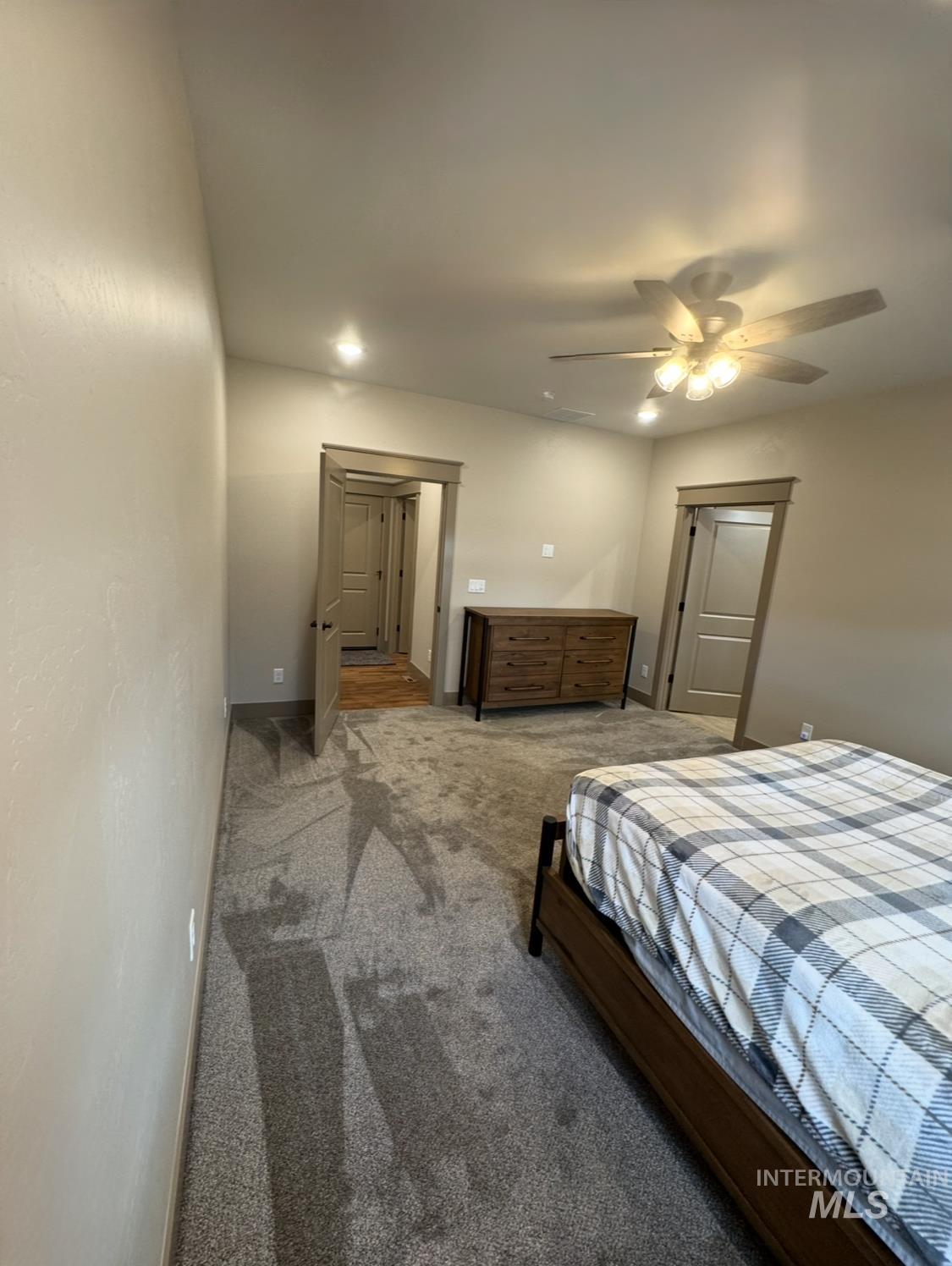 Carpeted bedroom featuring ceiling fan and recessed lighting