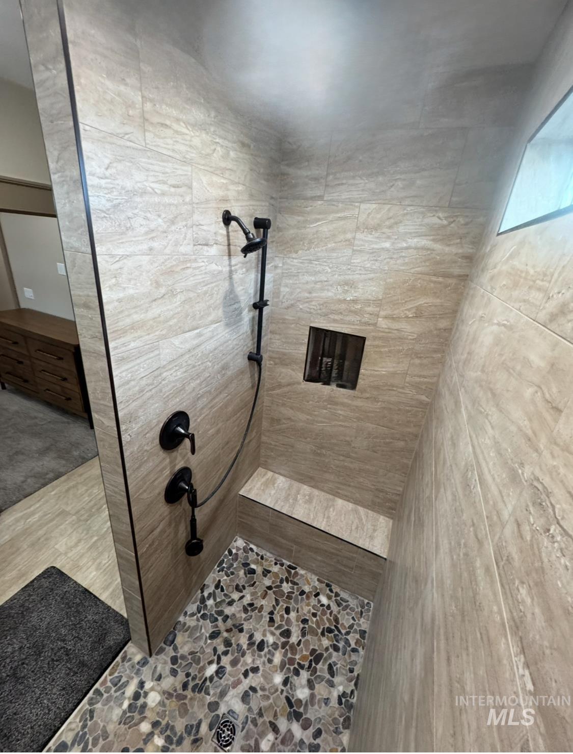 Full bath featuring a tile shower