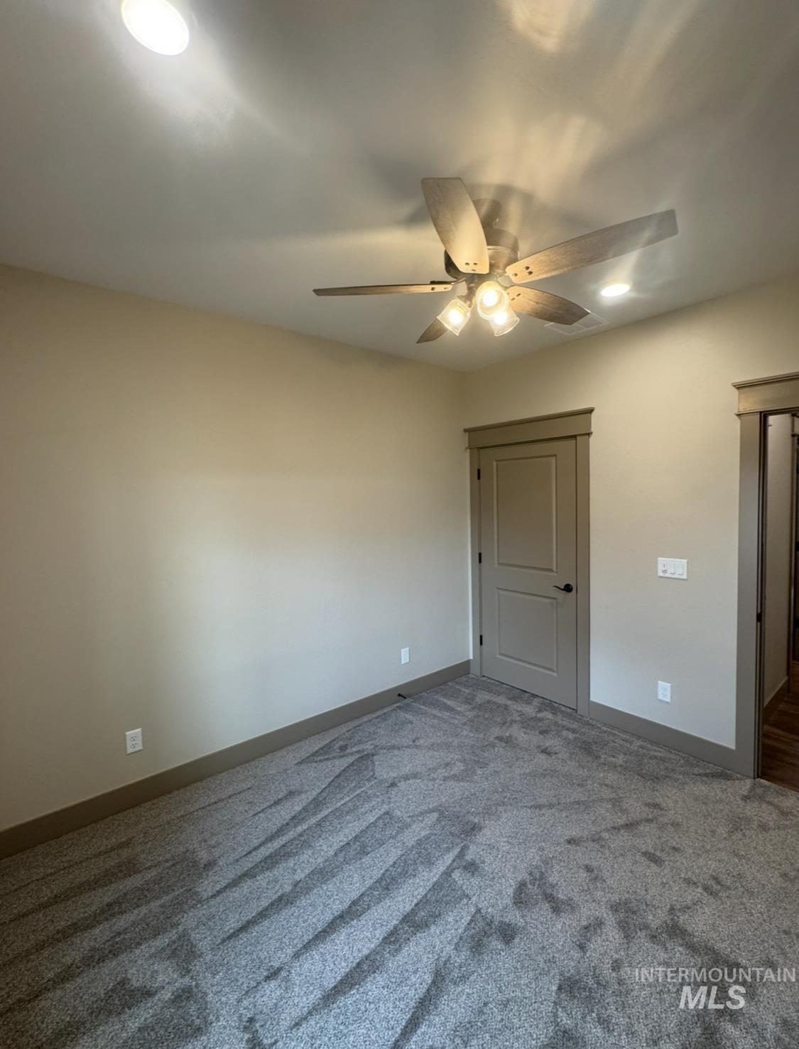 Unfurnished bedroom with carpet floors and a ceiling fan