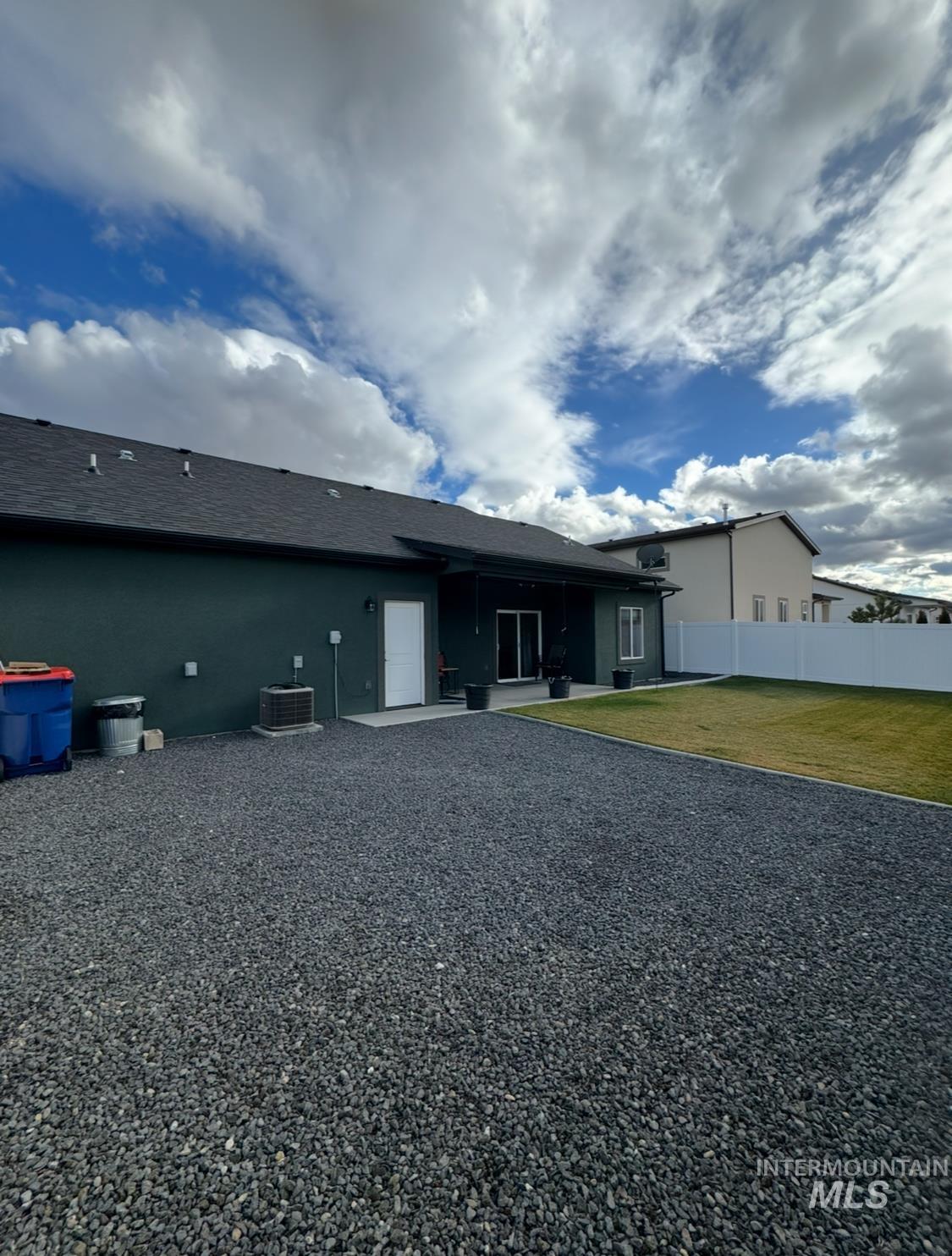 Back of house with a patio and a shingled roof