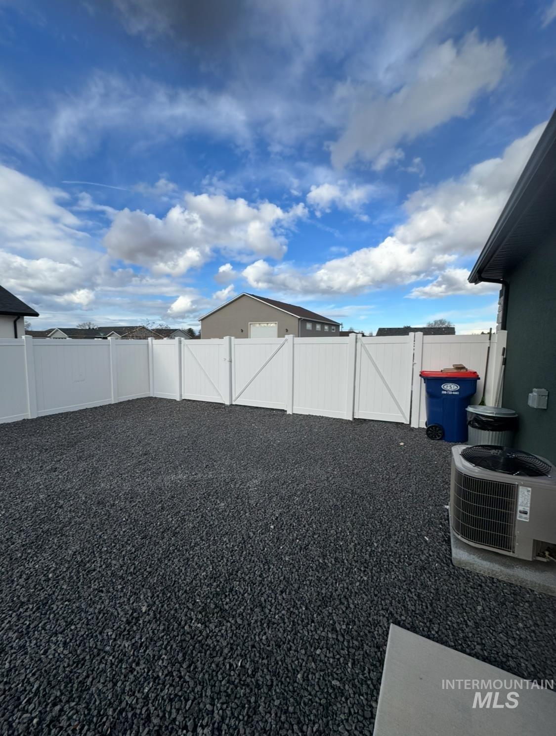 Fenced backyard featuring a gate