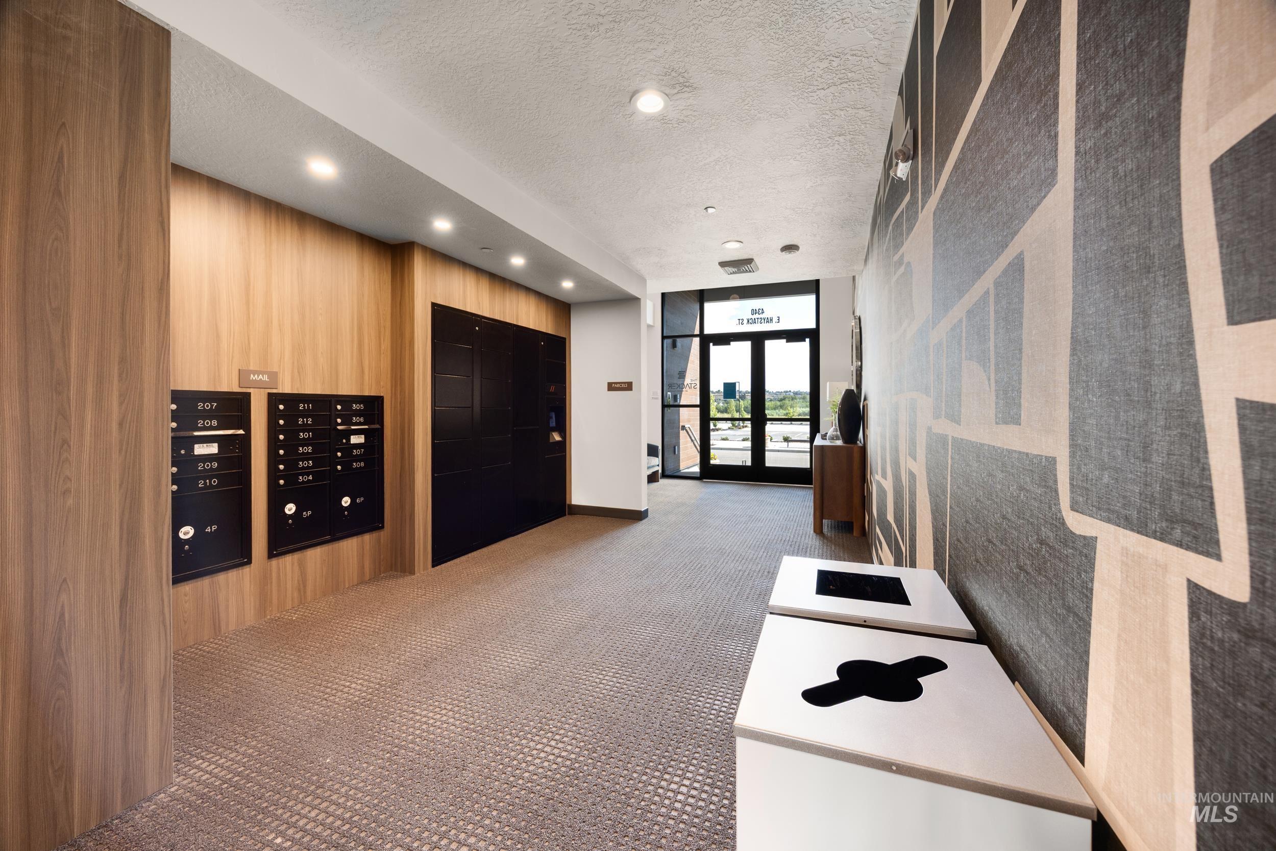Community lobby with a textured ceiling, expansive windows, and recessed lighting