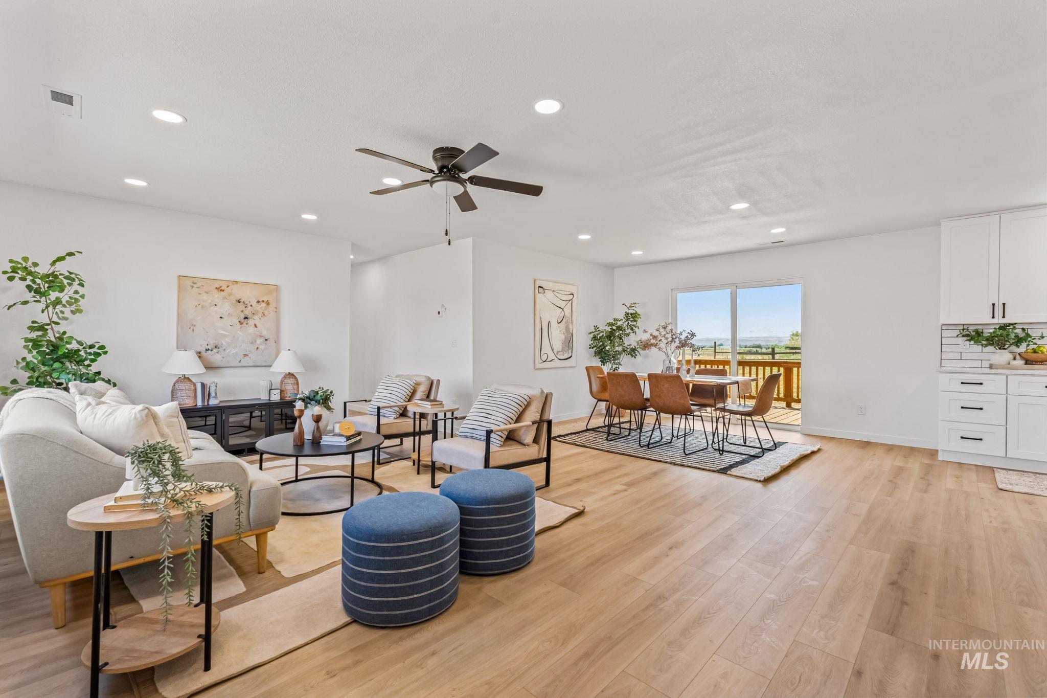 Living area with recessed lighting, light wood-type flooring, and a ceiling fan