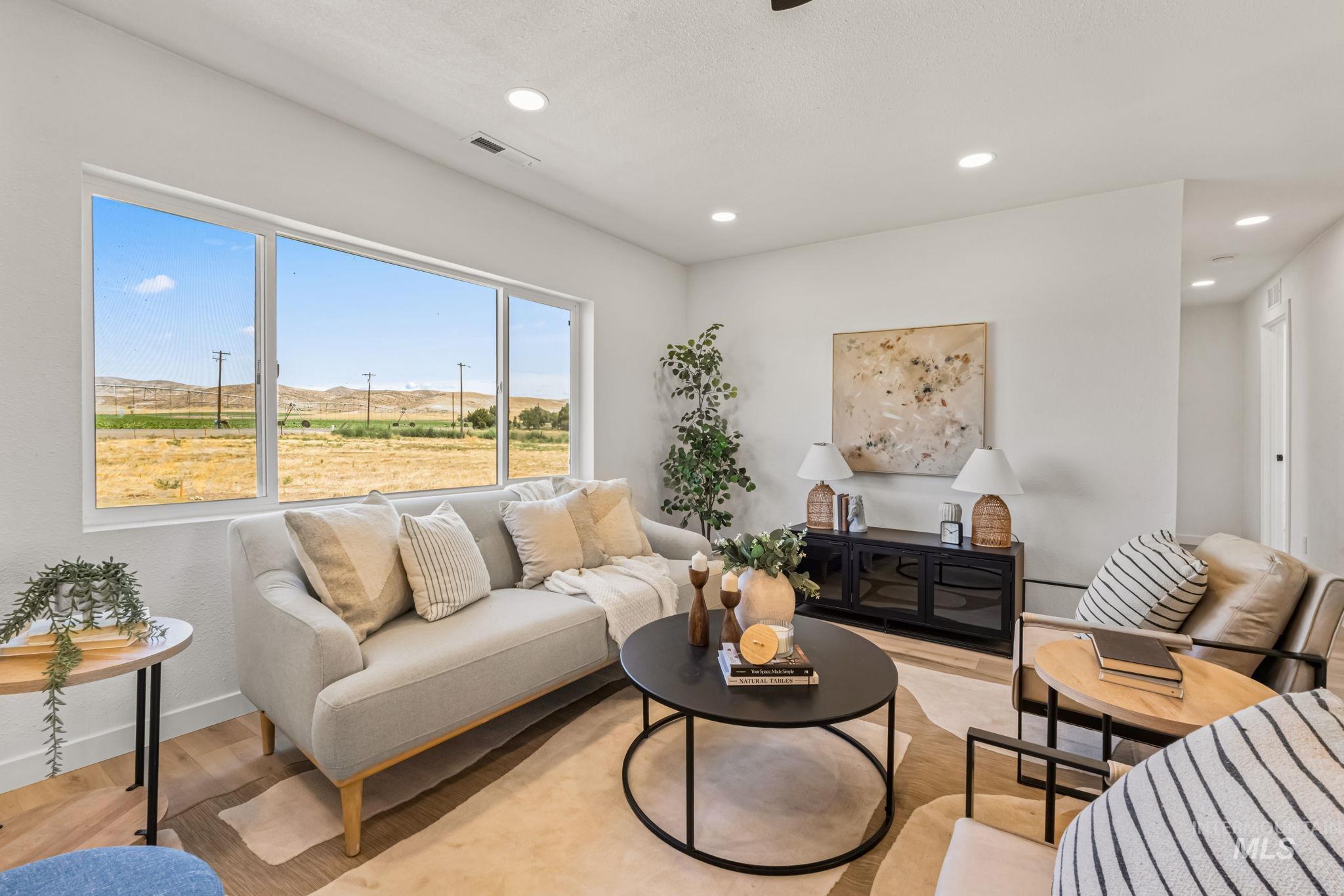 Living area with light wood finished floors, recessed lighting, and a mountain view