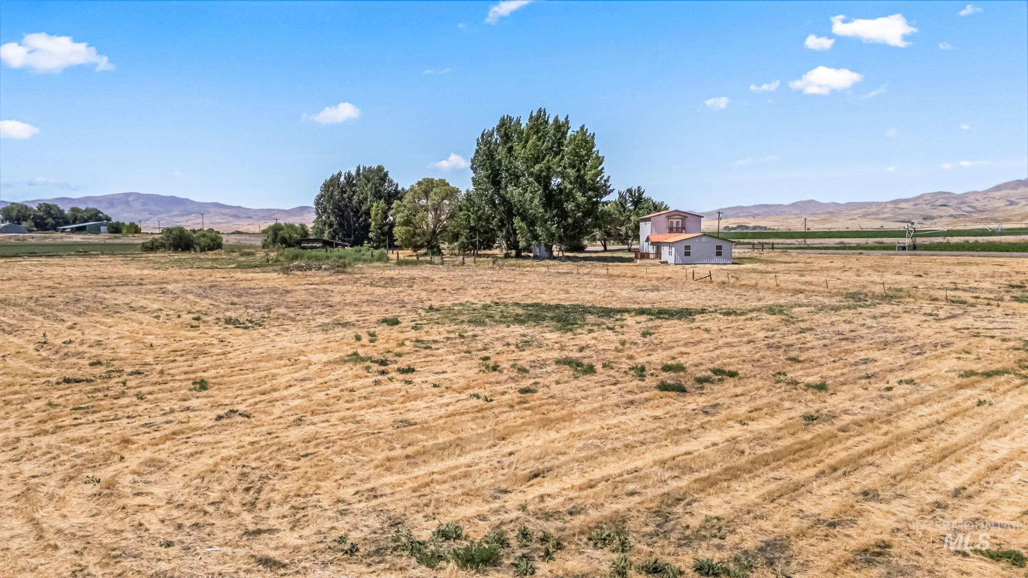 View of yard featuring a rural view and a mountain view