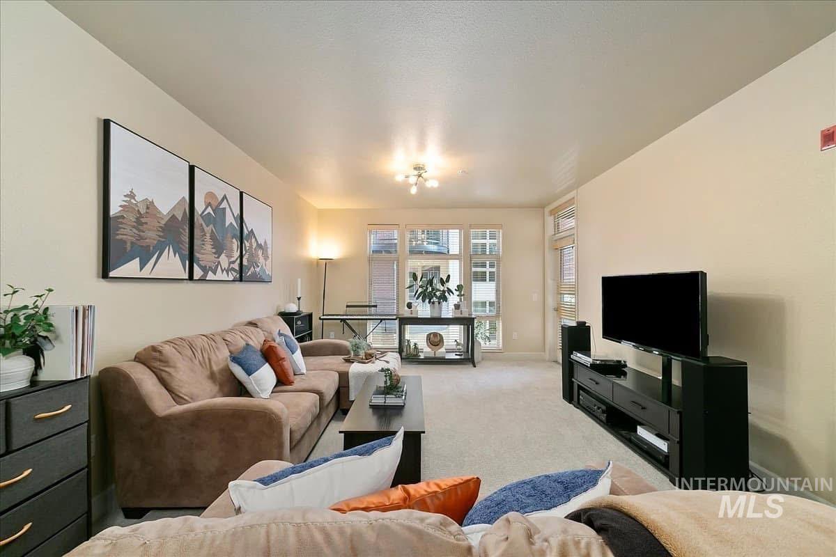 Living area with light carpet and baseboards