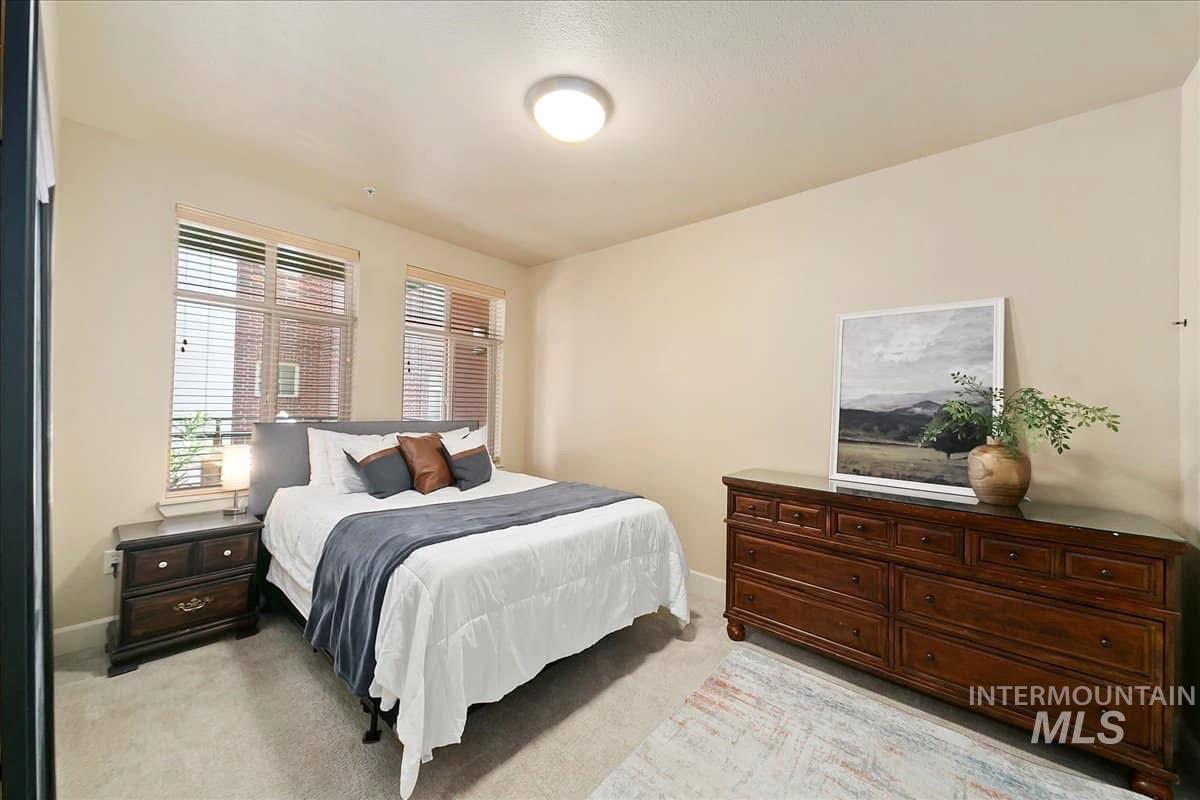 Bedroom featuring light colored carpet and baseboards