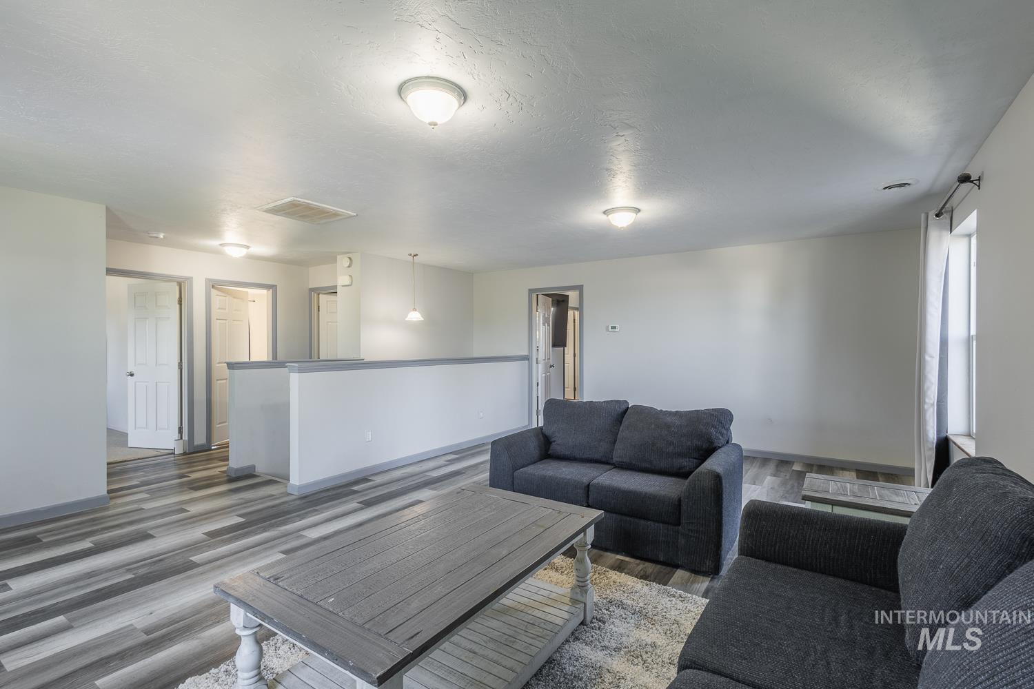 Living area with wood finished floors and a textured ceiling