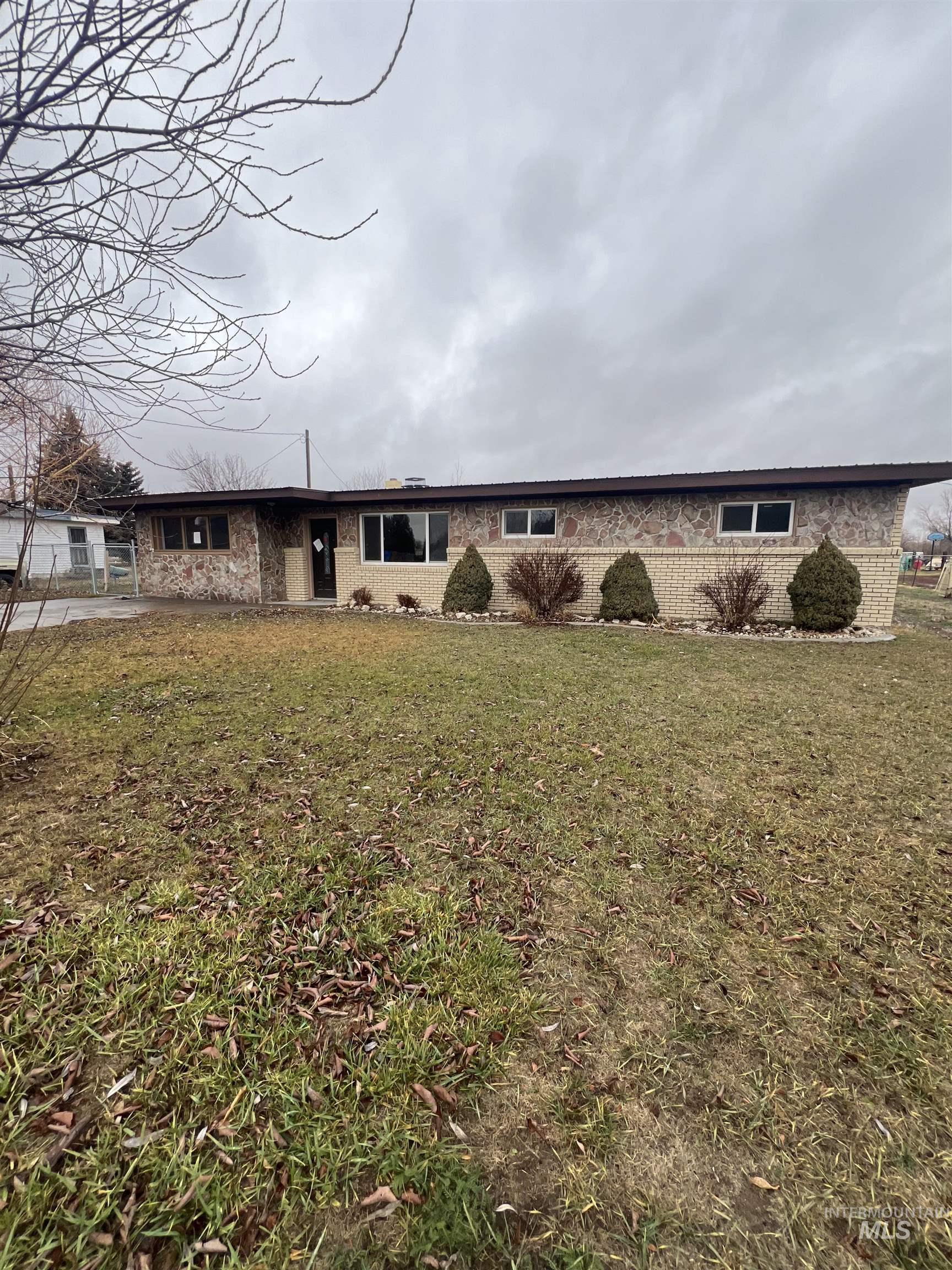 View of front facade with a front lawn and brick siding