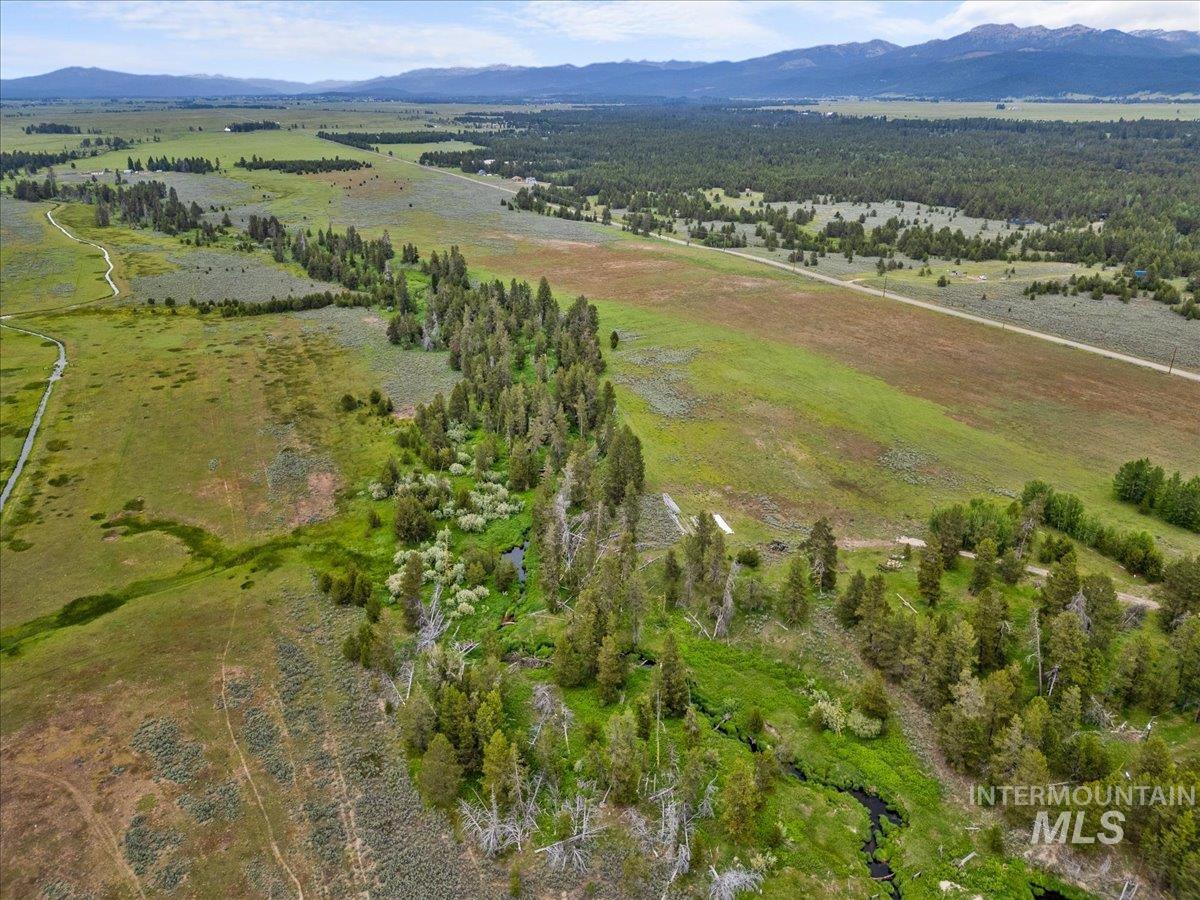 Aerial view of property's location with mountains and rural landscape