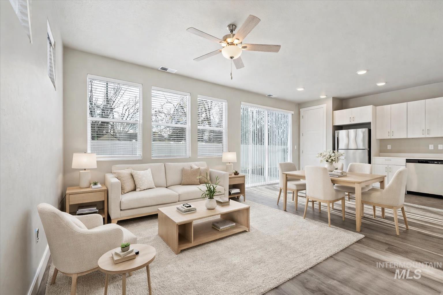 Living area featuring plenty of natural light, light wood-style floors, a ceiling fan, and recessed lighting
