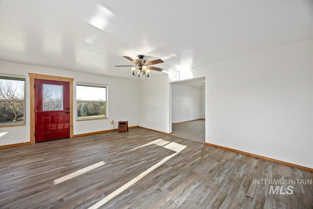 Foyer with wood finished floors and ceiling fan