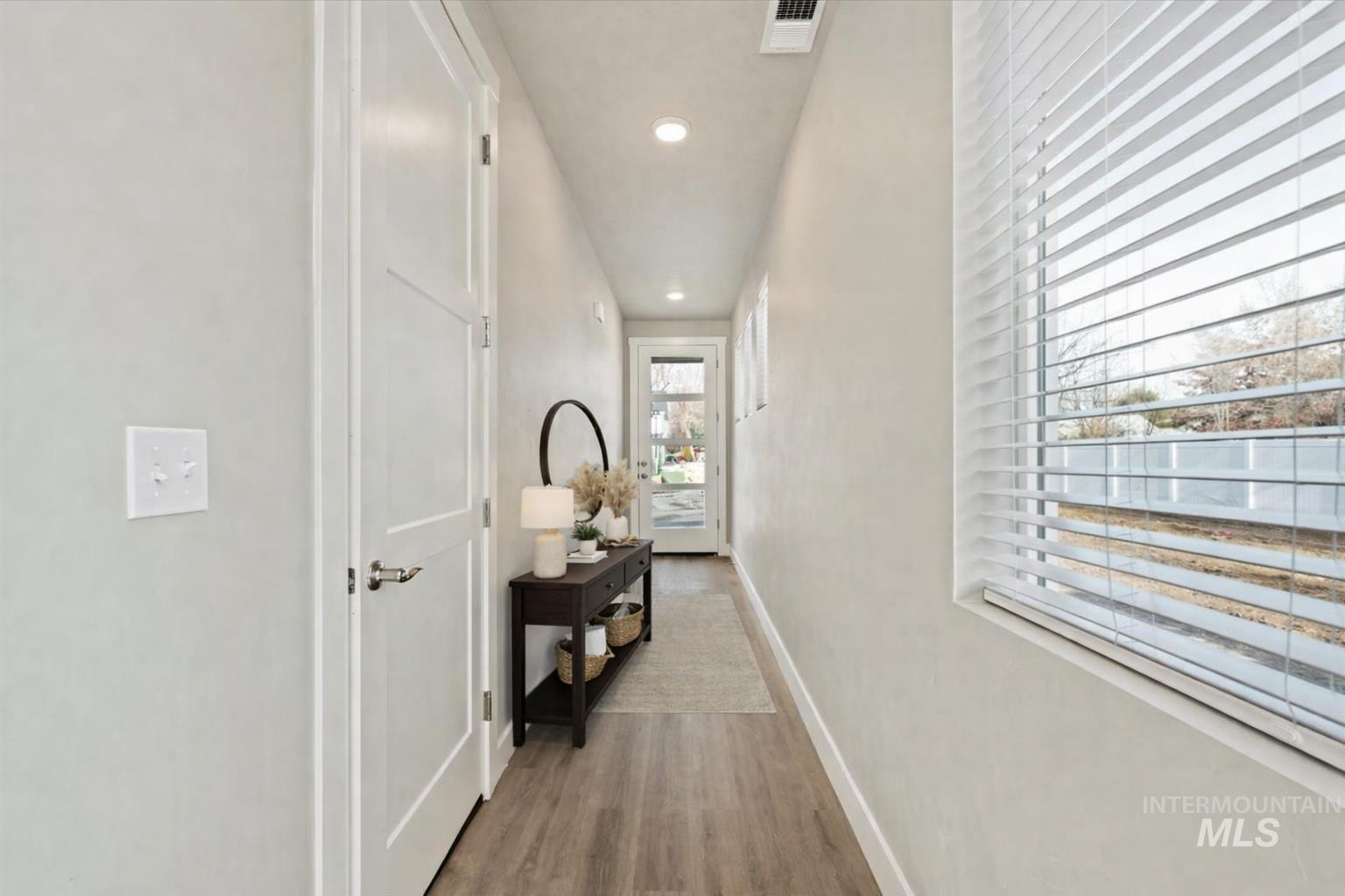 Hallway with recessed lighting and light wood finished floors