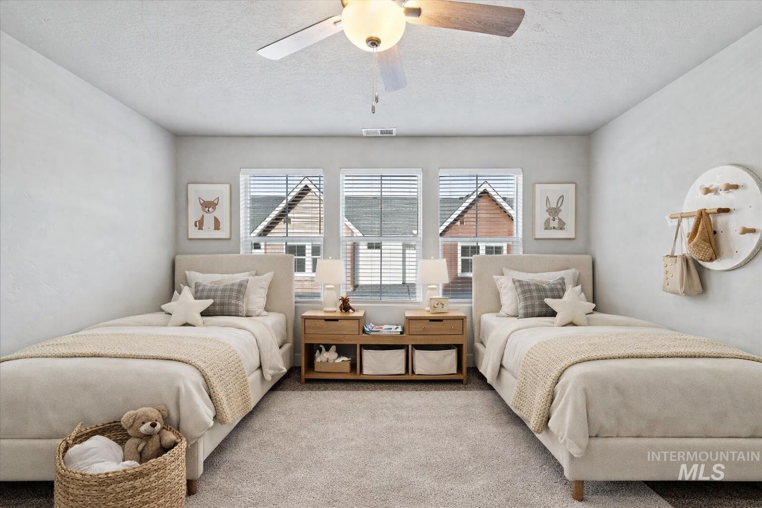 Bedroom with a textured ceiling, carpet, and a ceiling fan