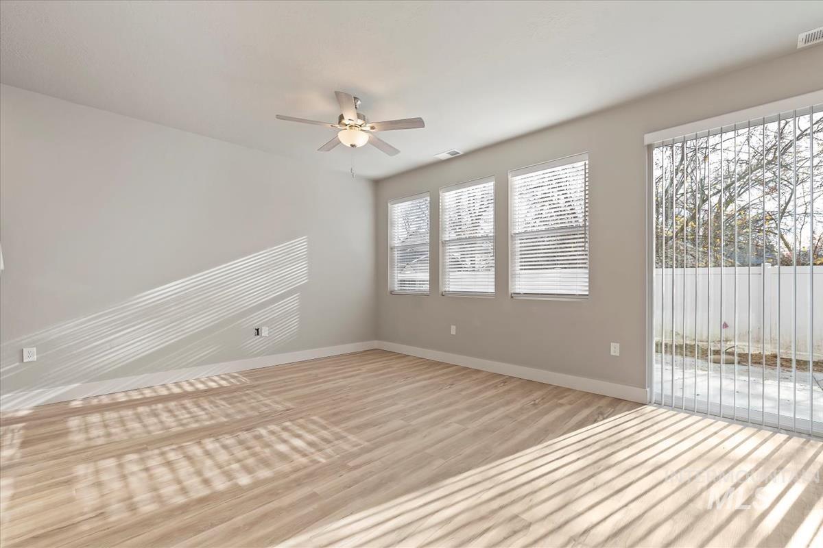 Spare room featuring light wood-style floors and ceiling fan