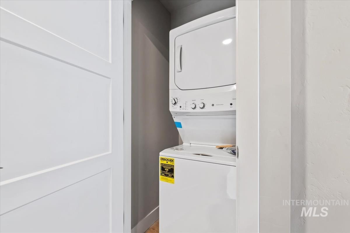 Laundry room featuring stacked washer and clothes dryer