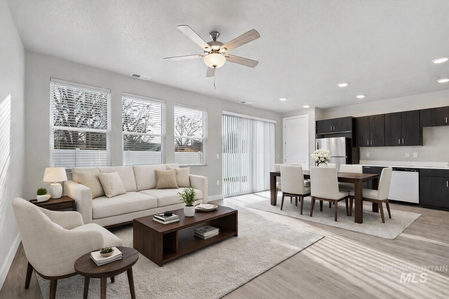 Living room featuring light wood-type flooring, ceiling fan, and recessed lighting