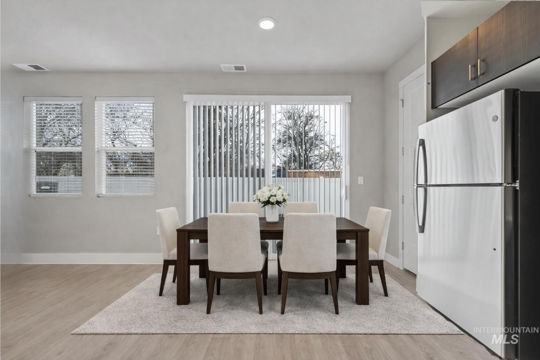Dining space featuring light wood-style flooring, healthy amount of natural light, and recessed lighting