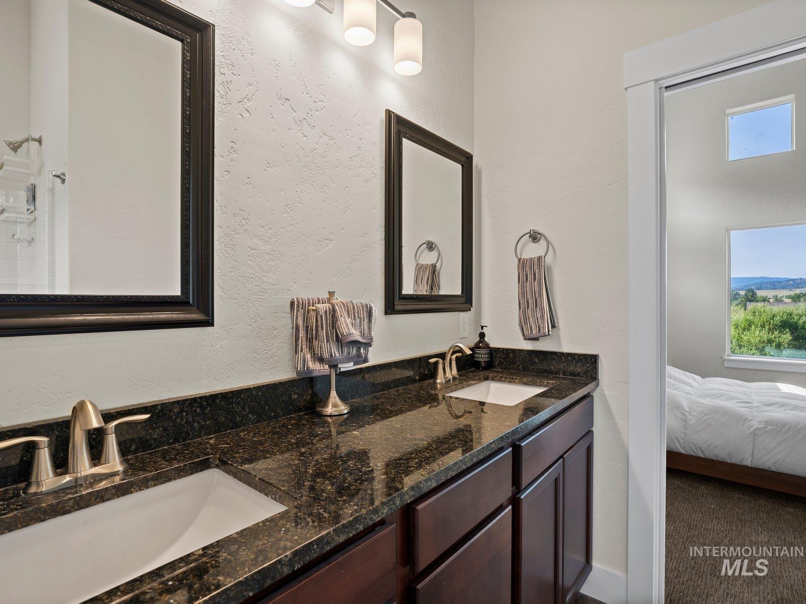 Full bath featuring dual vanities