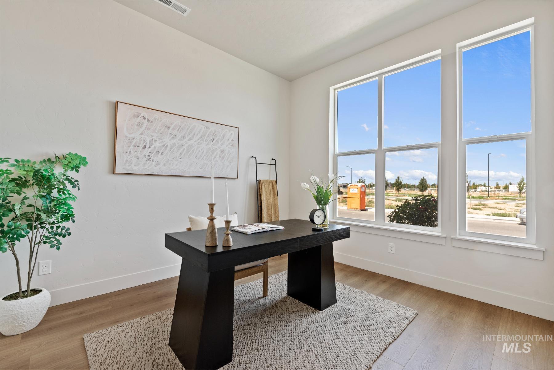 Home office with light wood-style flooring