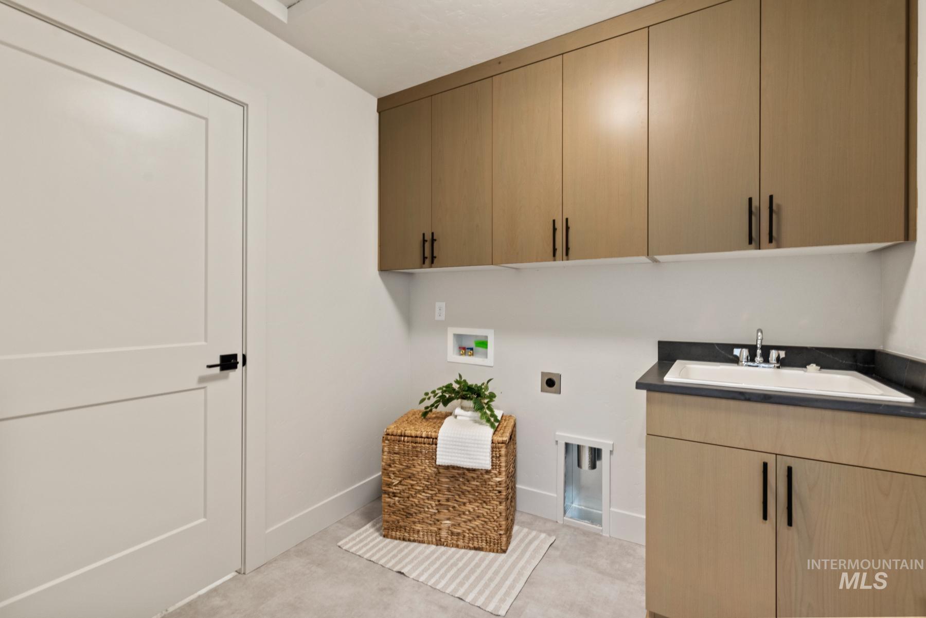 Laundry area featuring cabinet space, electric dryer hookup, washer hookup, and light colored carpet
