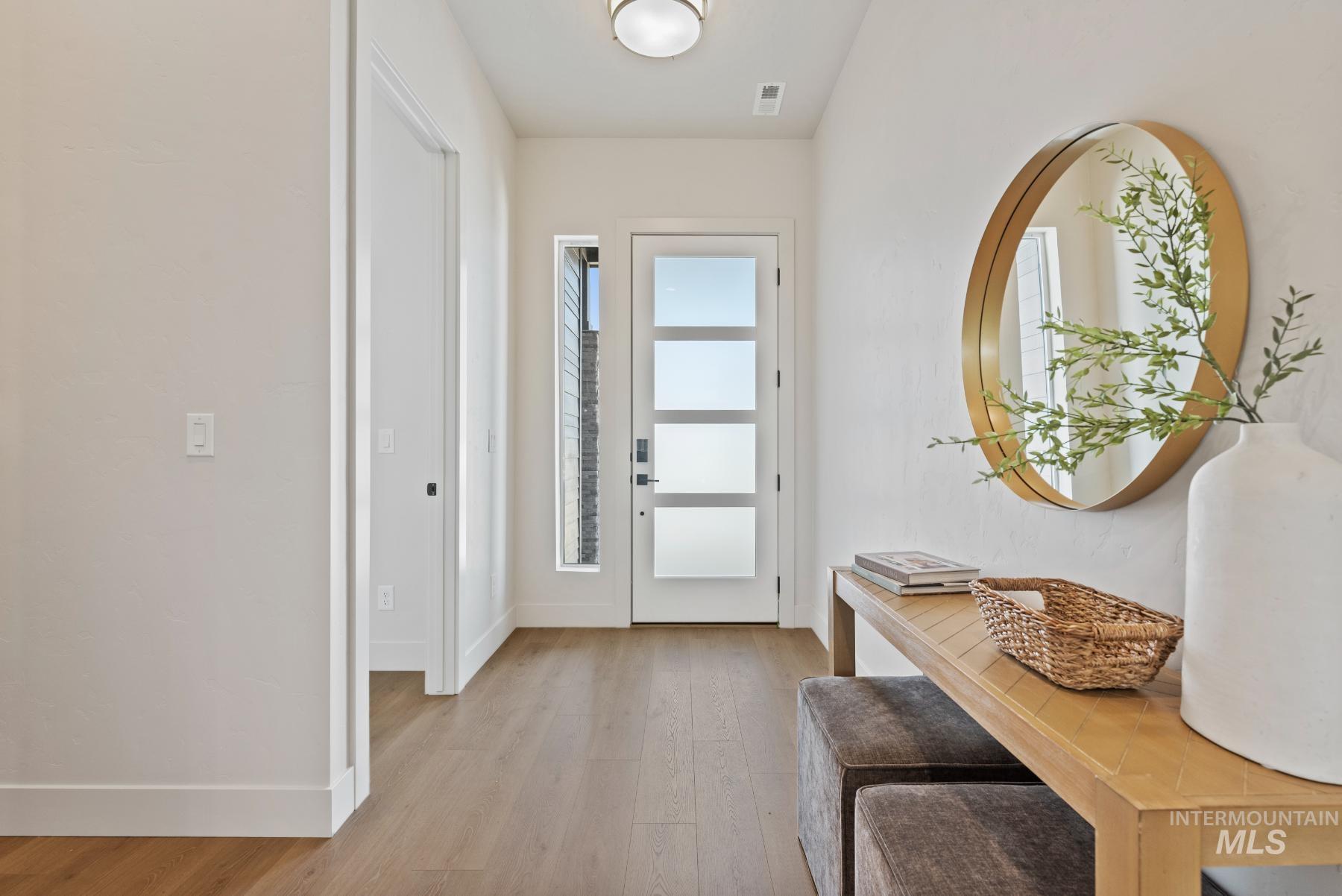 Foyer featuring light wood-type flooring and baseboards