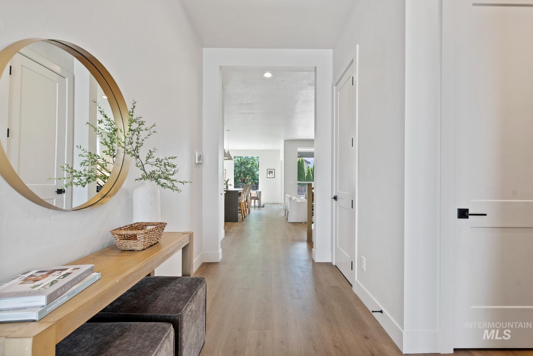 Hall featuring light wood finished floors and baseboards