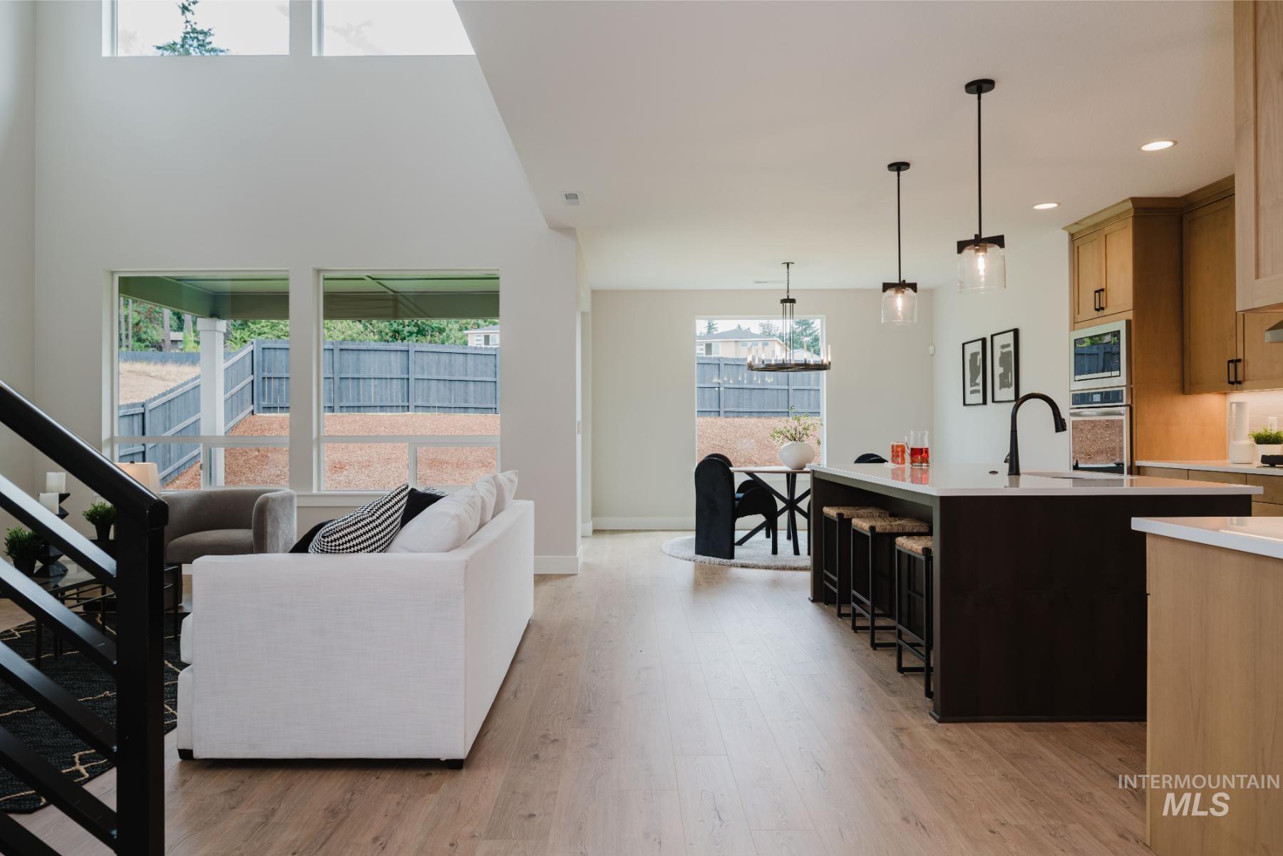 Living room featuring light wood-style flooring, recessed lighting, and a chandelier