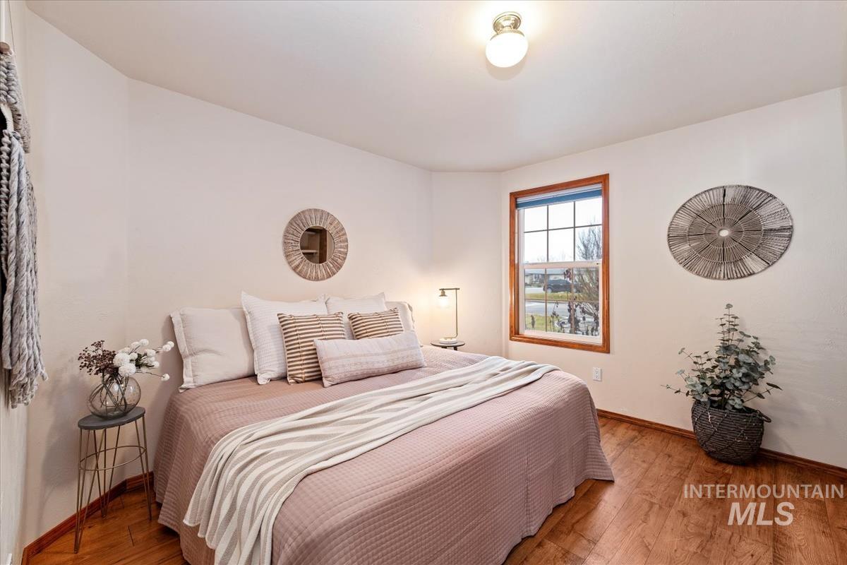 Bedroom with wood-type flooring and baseboards