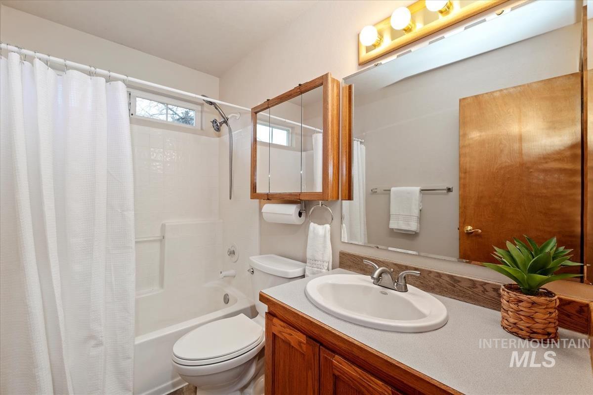 Bathroom featuring vanity and shower / tub combo