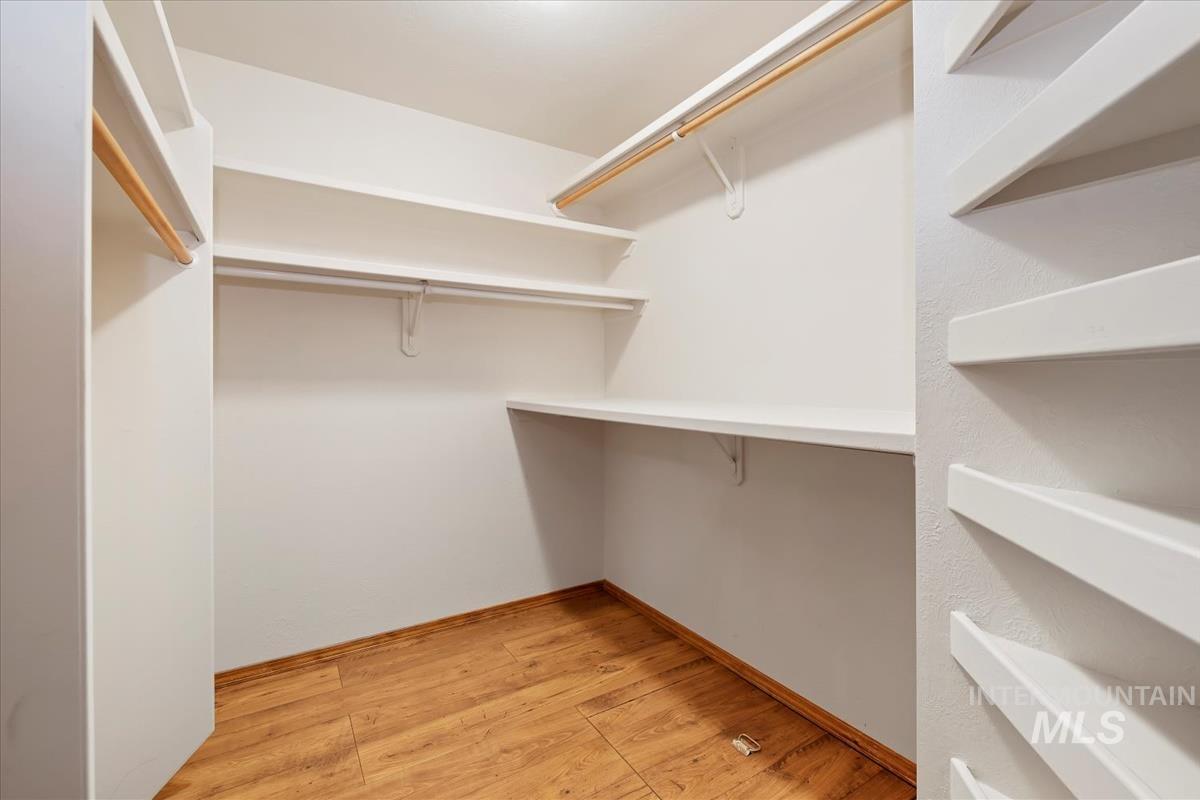 Walk in closet featuring light wood-style floors