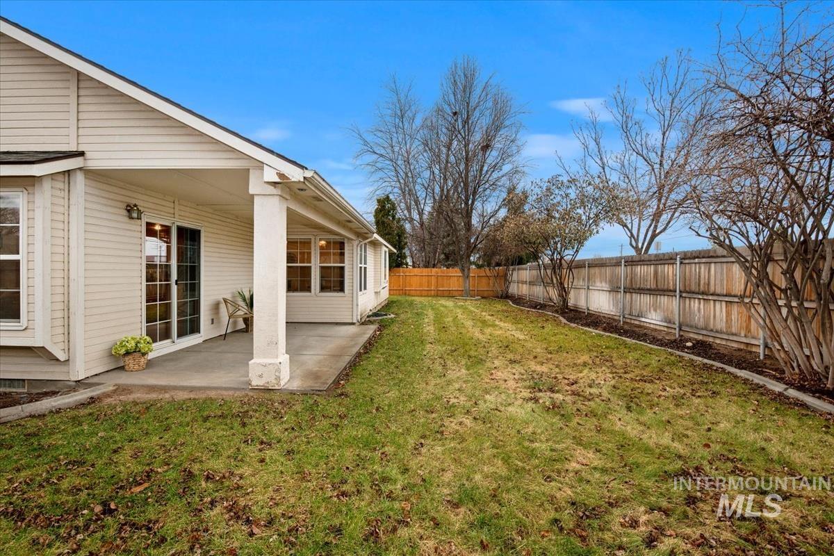 Fenced backyard featuring a patio