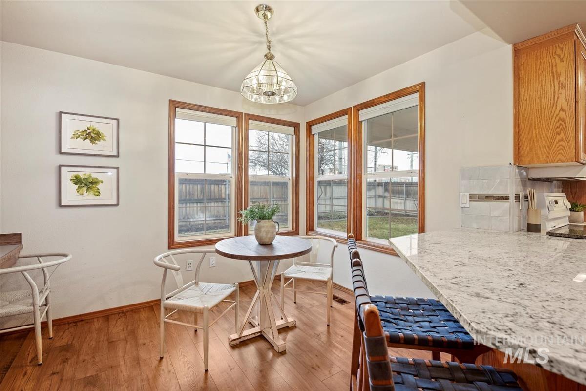 Dining room featuring light wood-type flooring and a chandelier