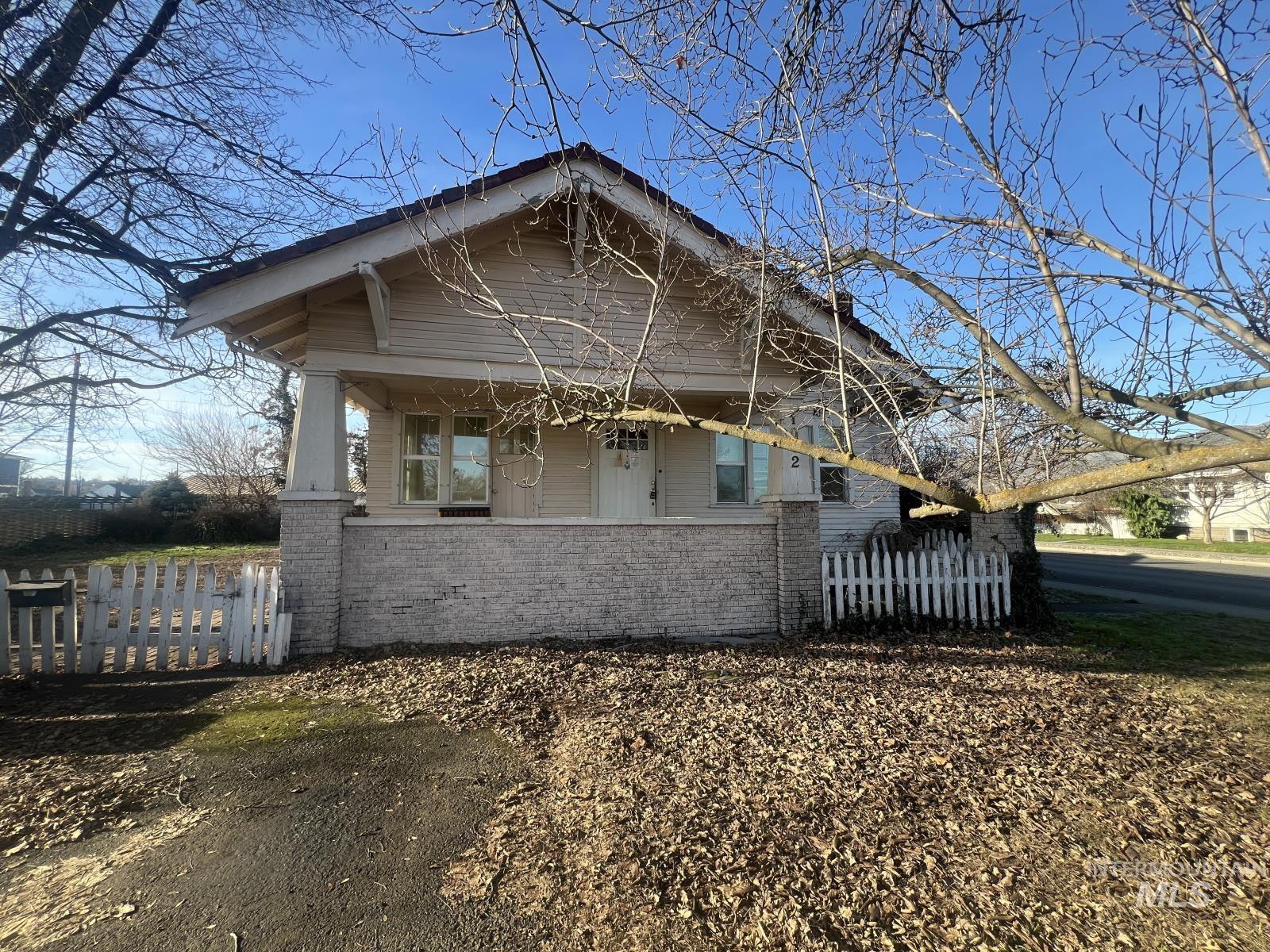 View of front of house with brick siding and a porch