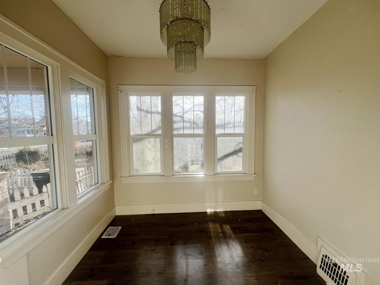 Unfurnished sunroom with a chandelier
