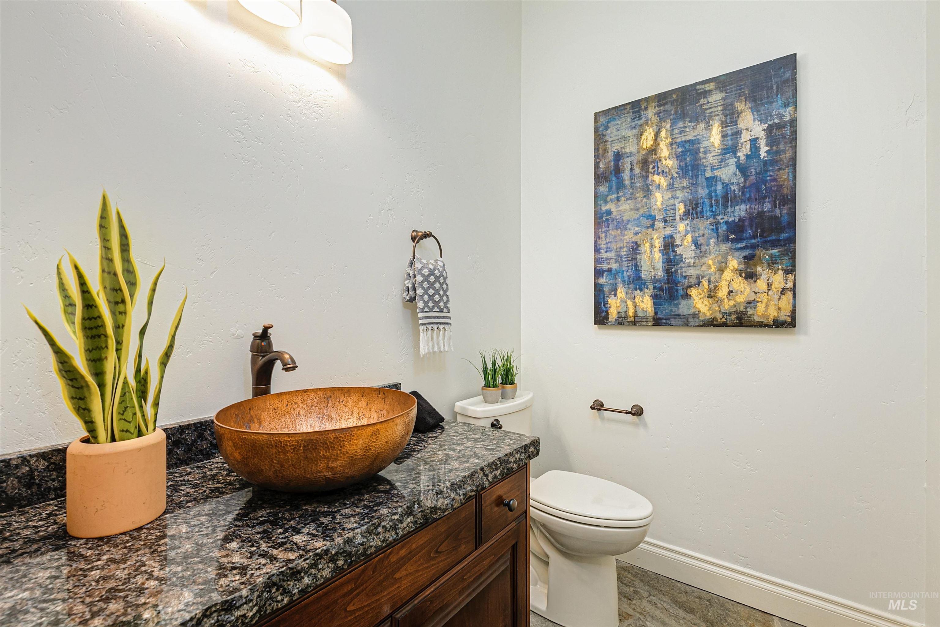 Half bath featuring vanity and baseboards
