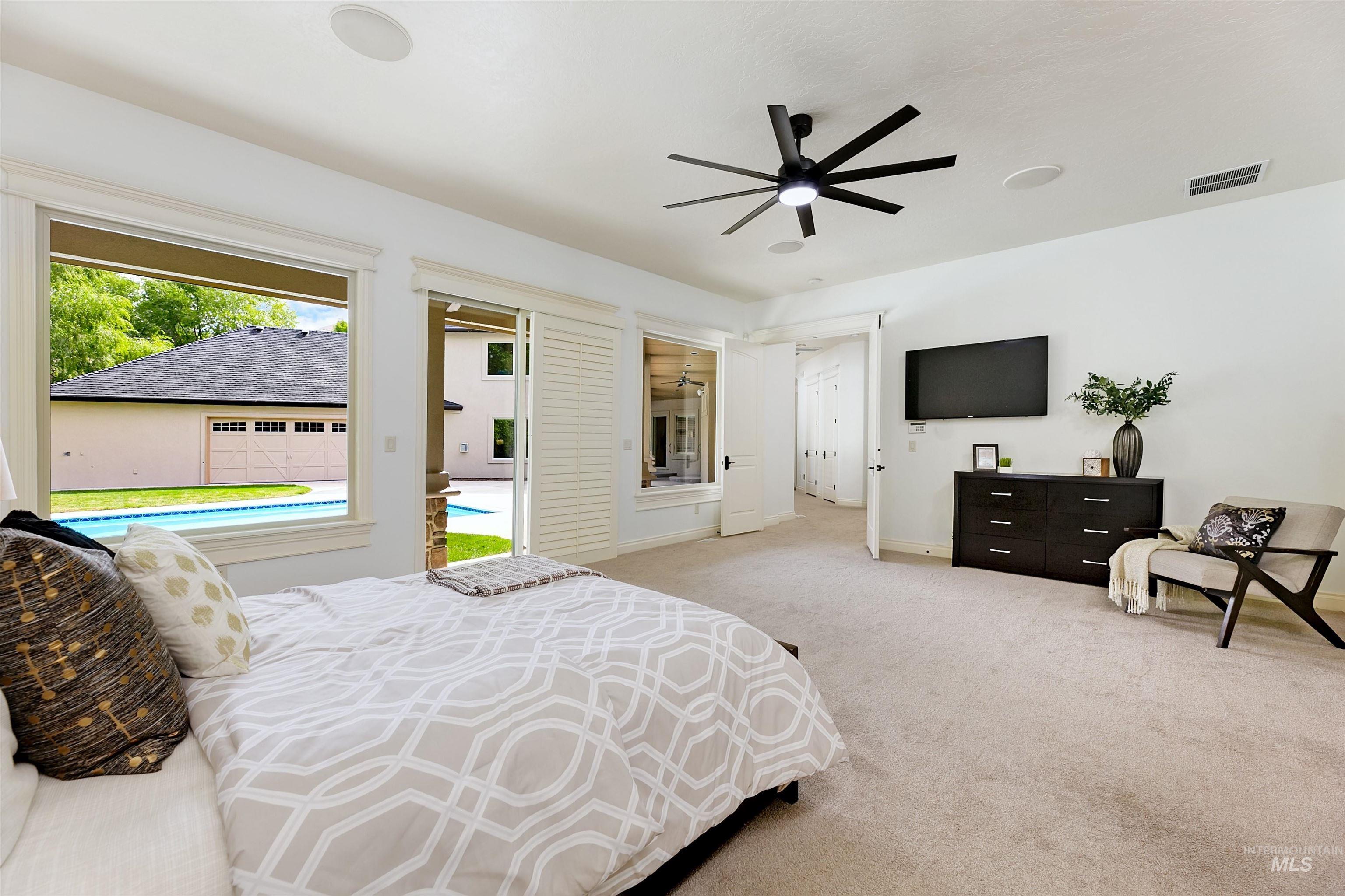 Bedroom with access to outside, carpet, and ceiling fan