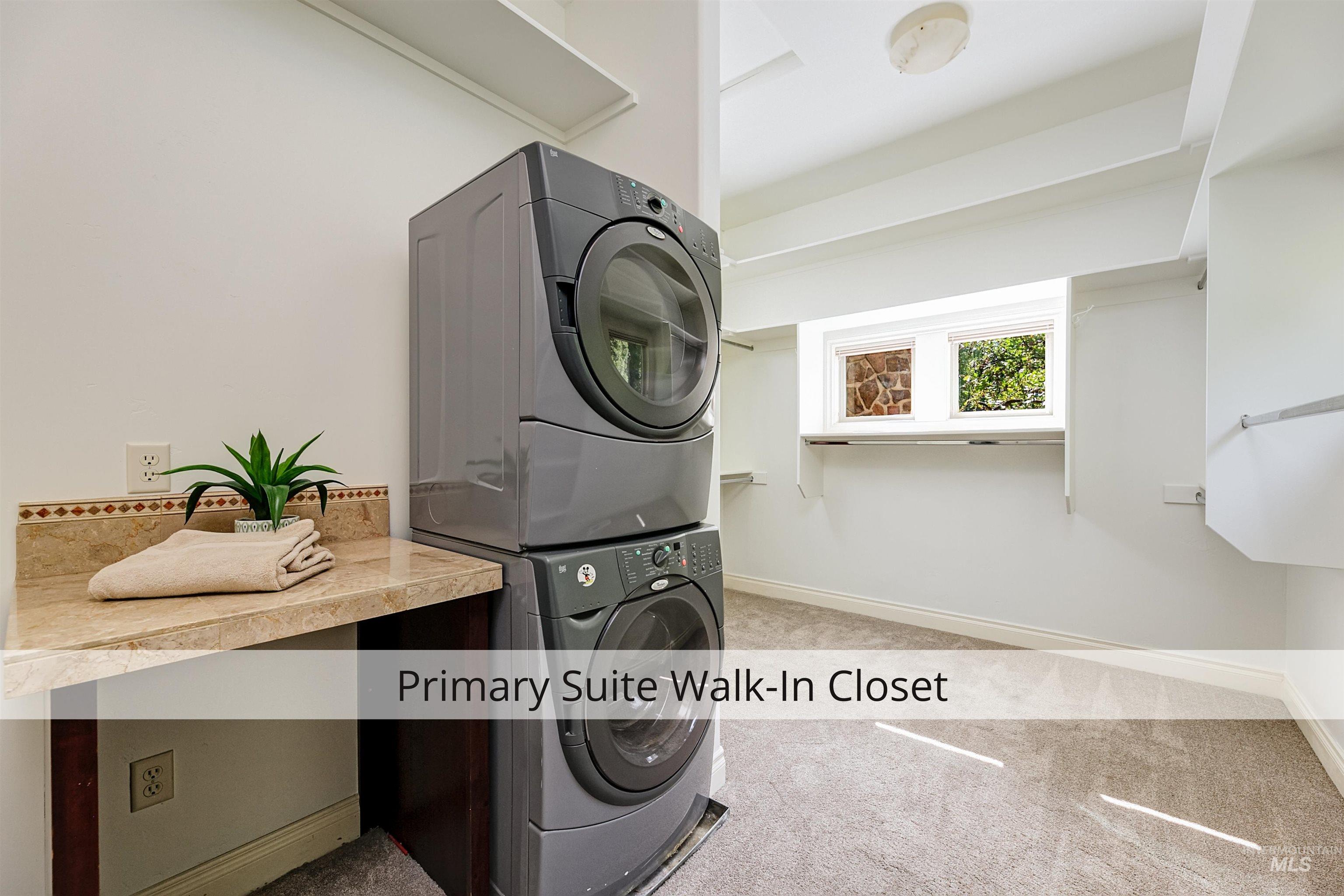 Washroom featuring light carpet and estacked washer and dryer
