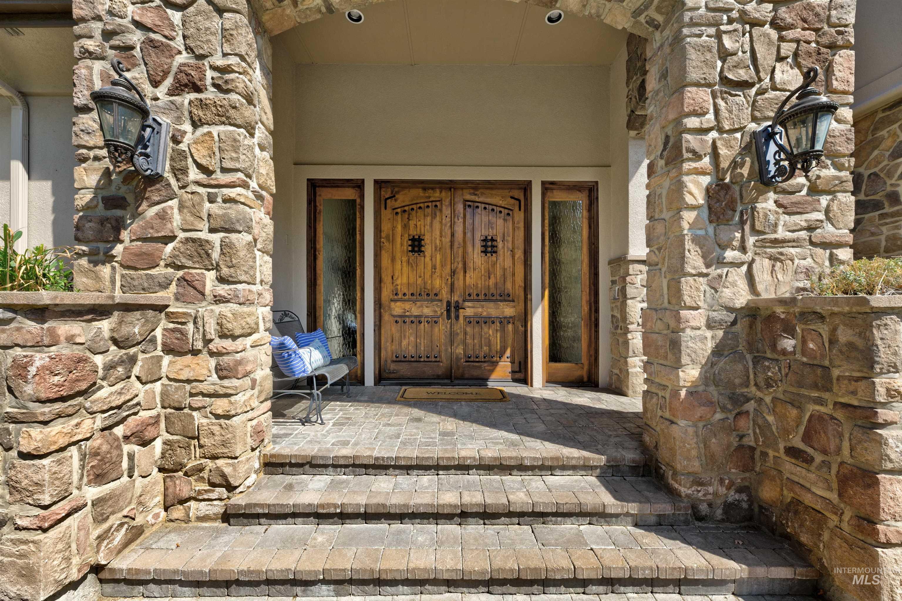 Entrance to property featuring stone siding