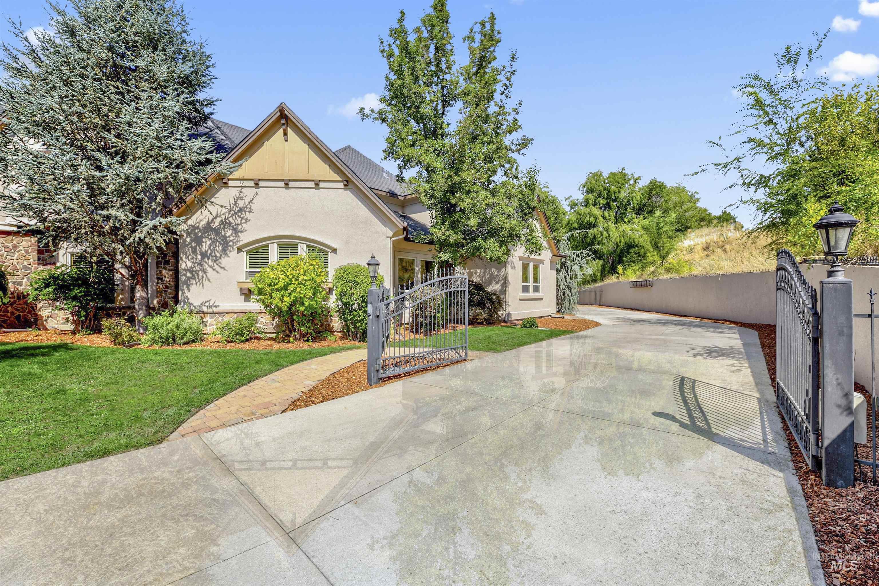 View of front of home featuring a gate and stucco siding