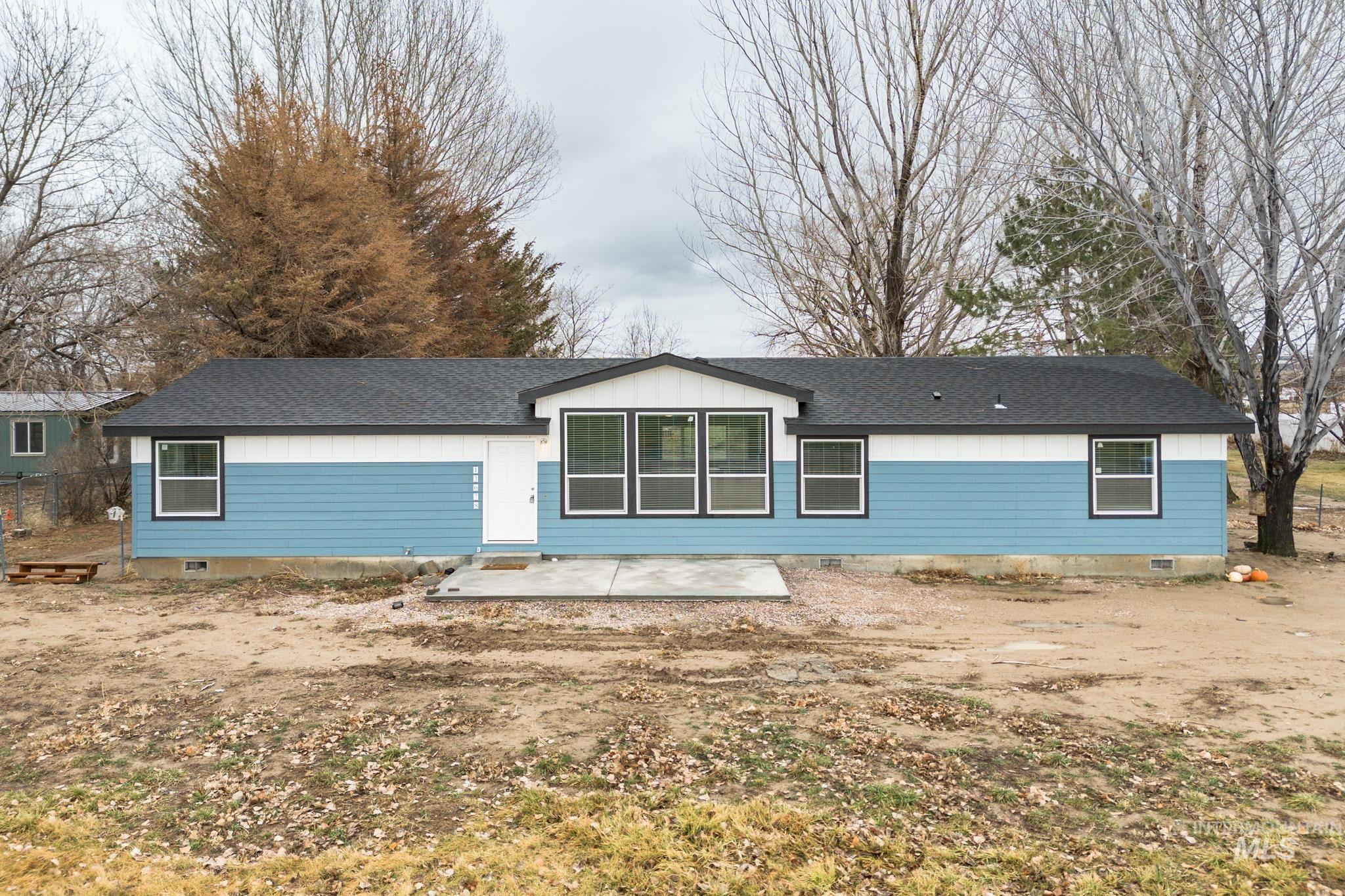 Back of house featuring crawl space, a patio, and a shingled roof