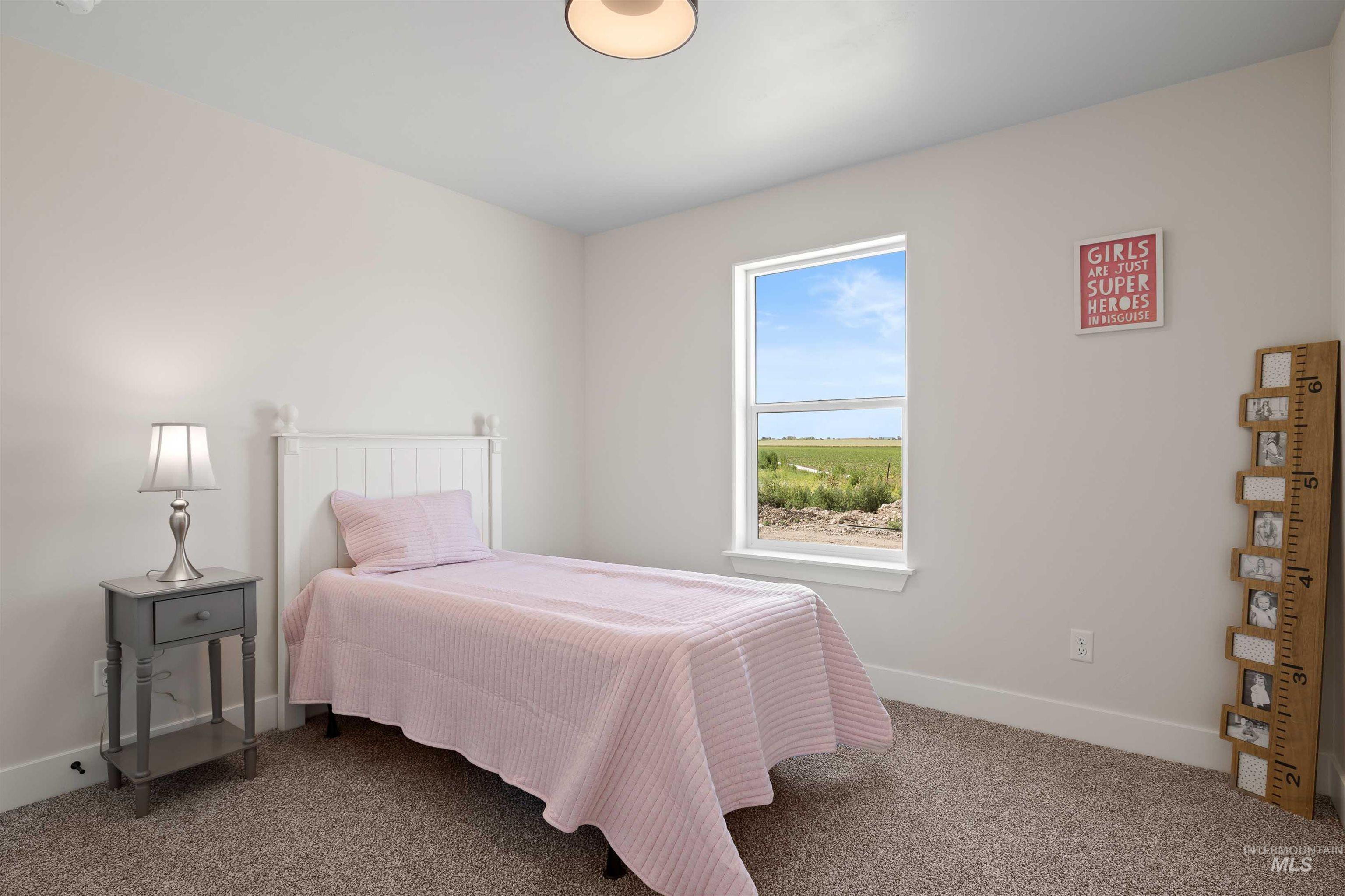 Carpeted bedroom with baseboards