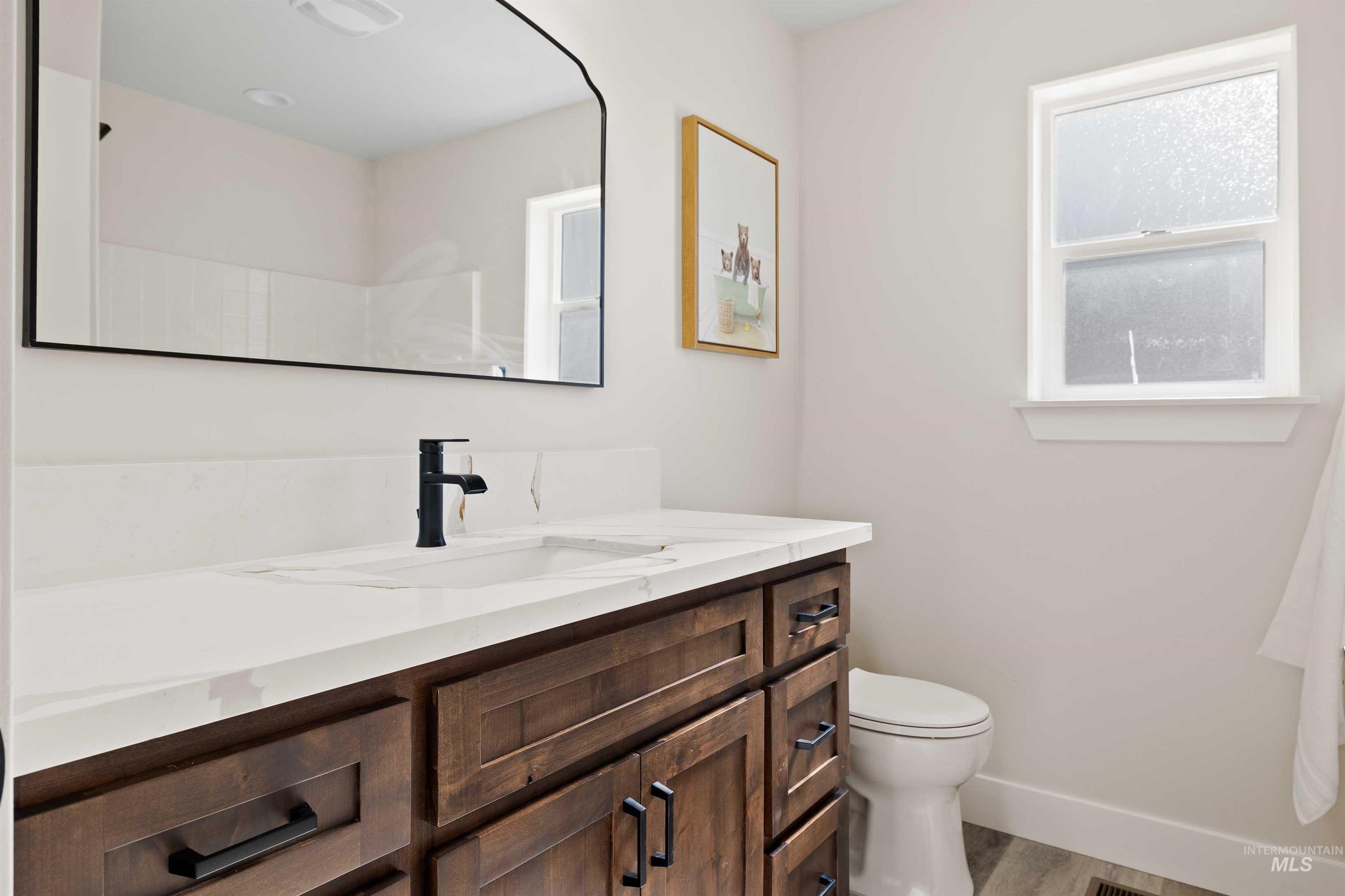 Bathroom featuring vanity and wood finished floors
