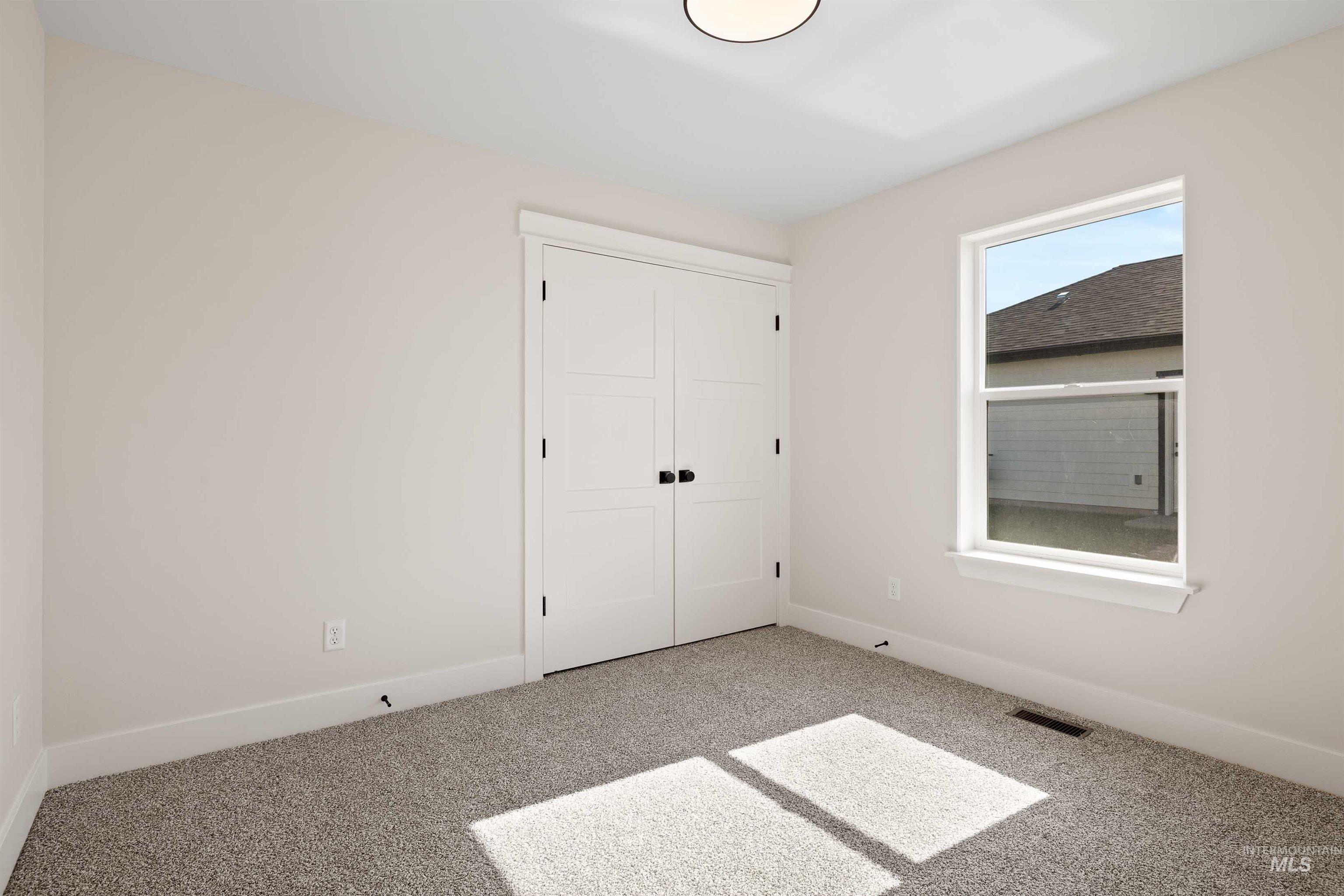 Unfurnished bedroom with carpet and a closet